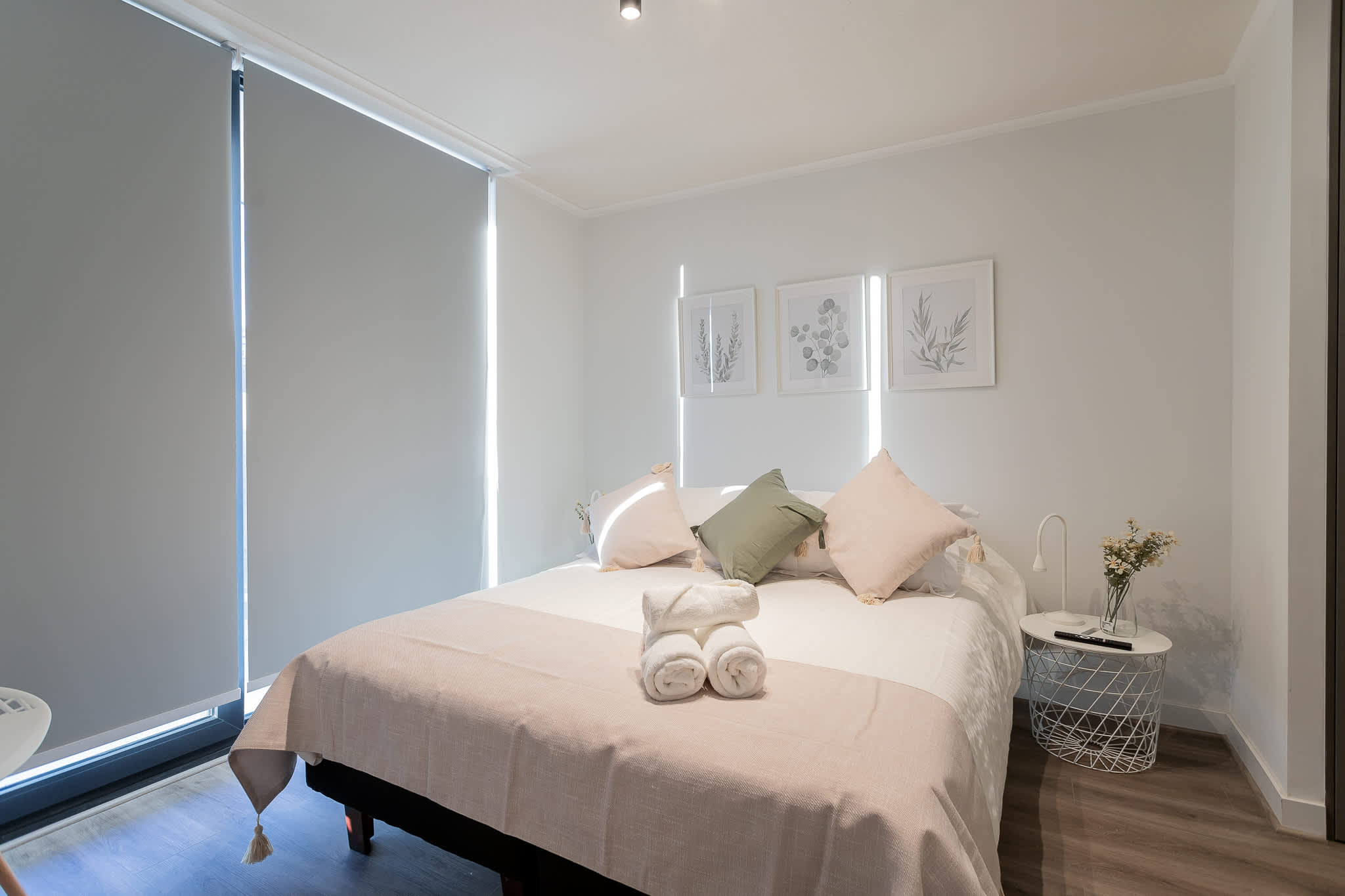 Relax in this cozy bedroom with soft linens and calming decor, perfect for unwinding after a day exploring the city.