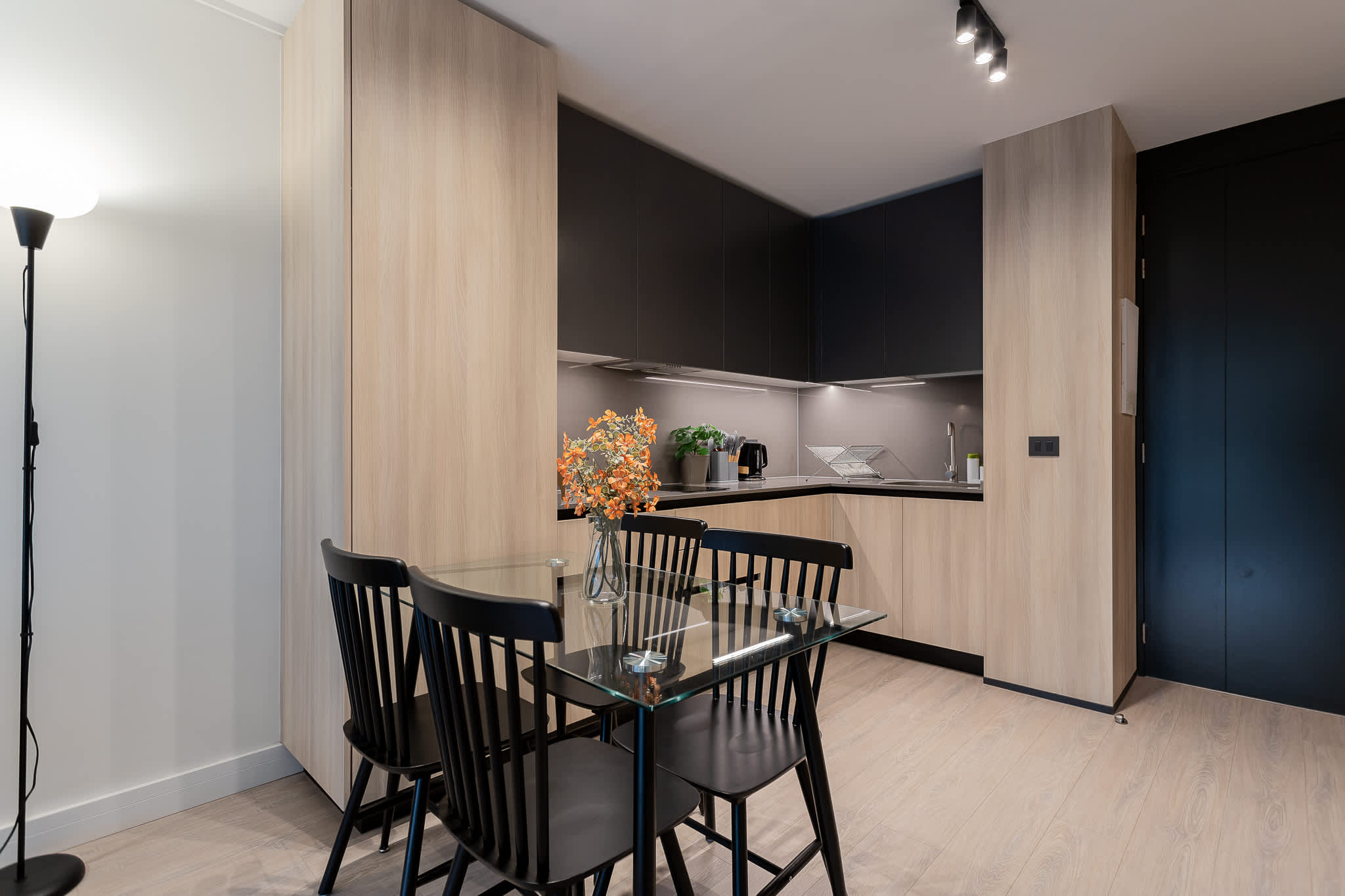 Experience a modern kitchen with sleek cabinetry and a cozy dining area, perfect for enjoying meals together in style.