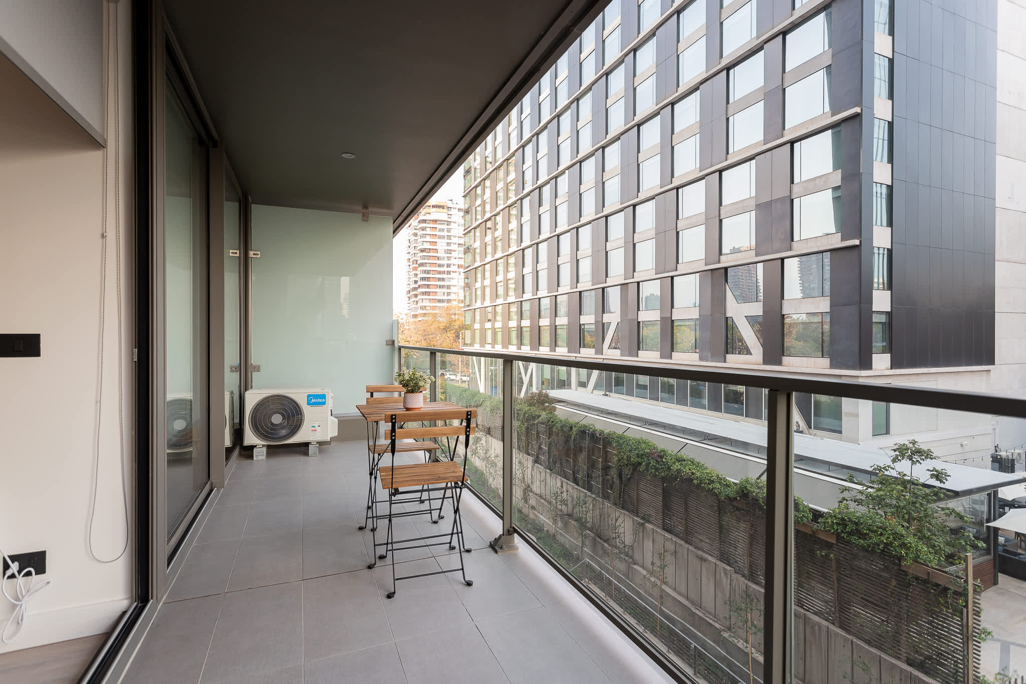 Enjoy a cozy balcony with seating, perfect for morning coffee while overlooking the cityscape.