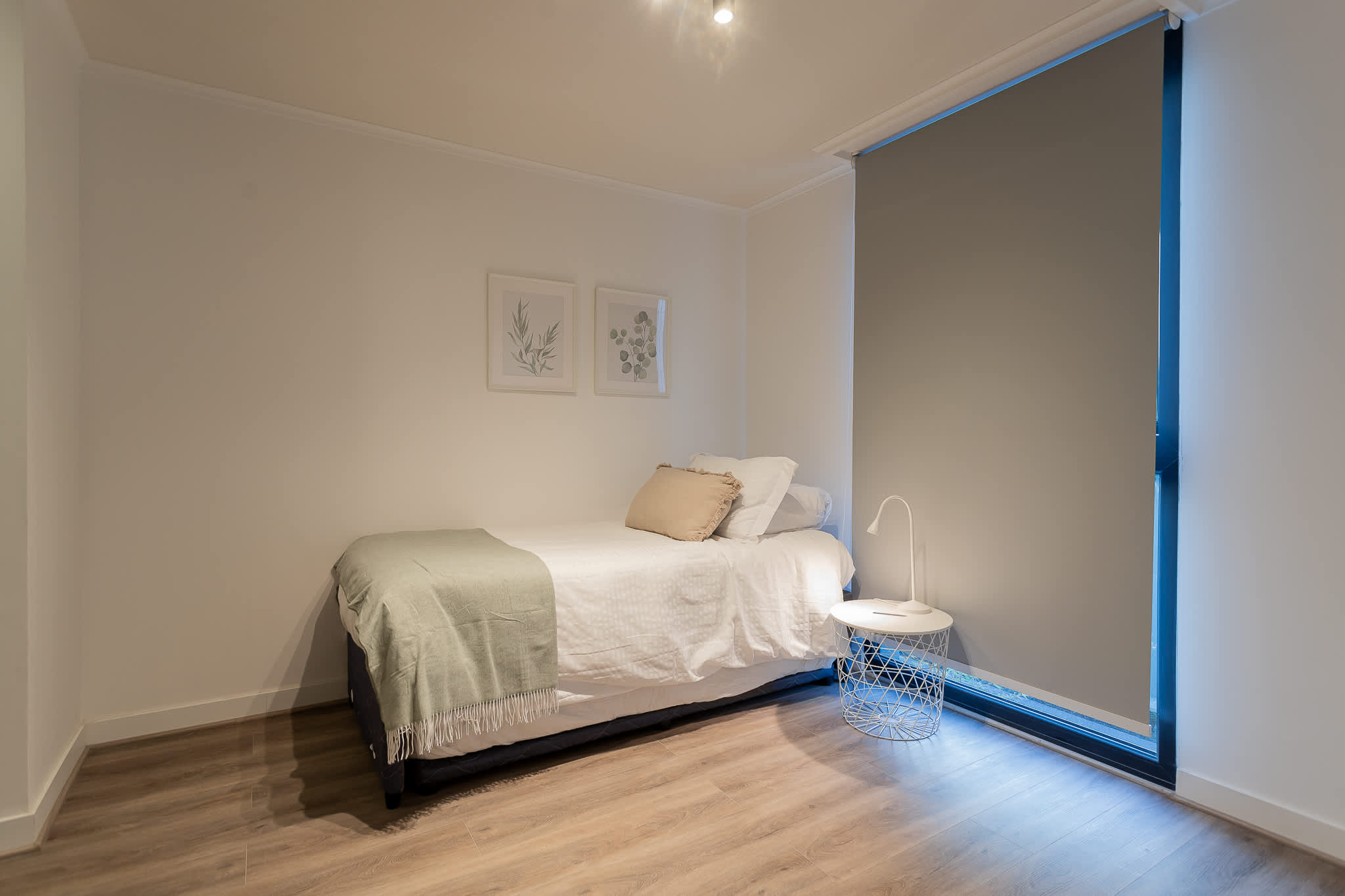 Cozy and minimalist bedroom with natural light, perfect for a restful stay. Enjoy a peaceful retreat in this serene space.