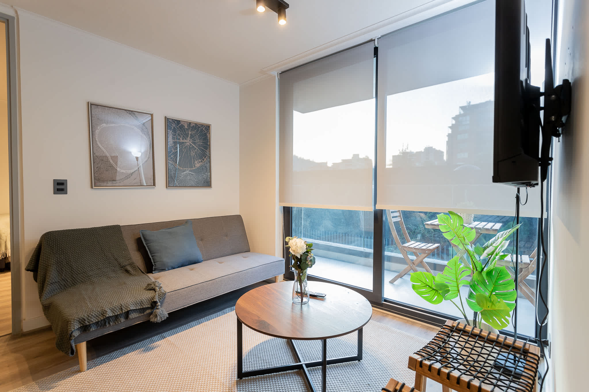 Bright and cozy living room with a balcony view, perfect for relaxing after a day of adventure.