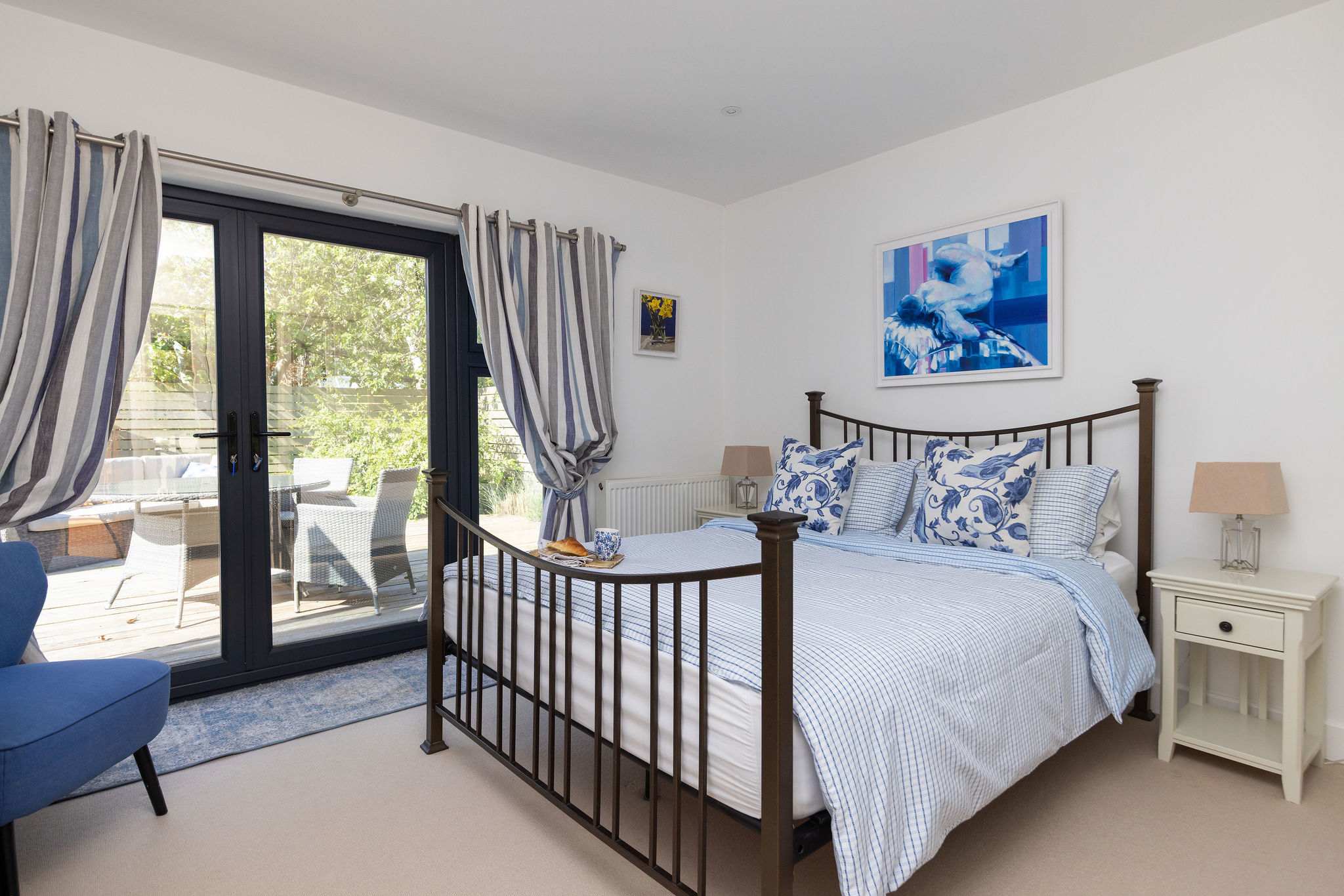 The master bedroom offers a comfortable king-size bed and direct access to your private patio.