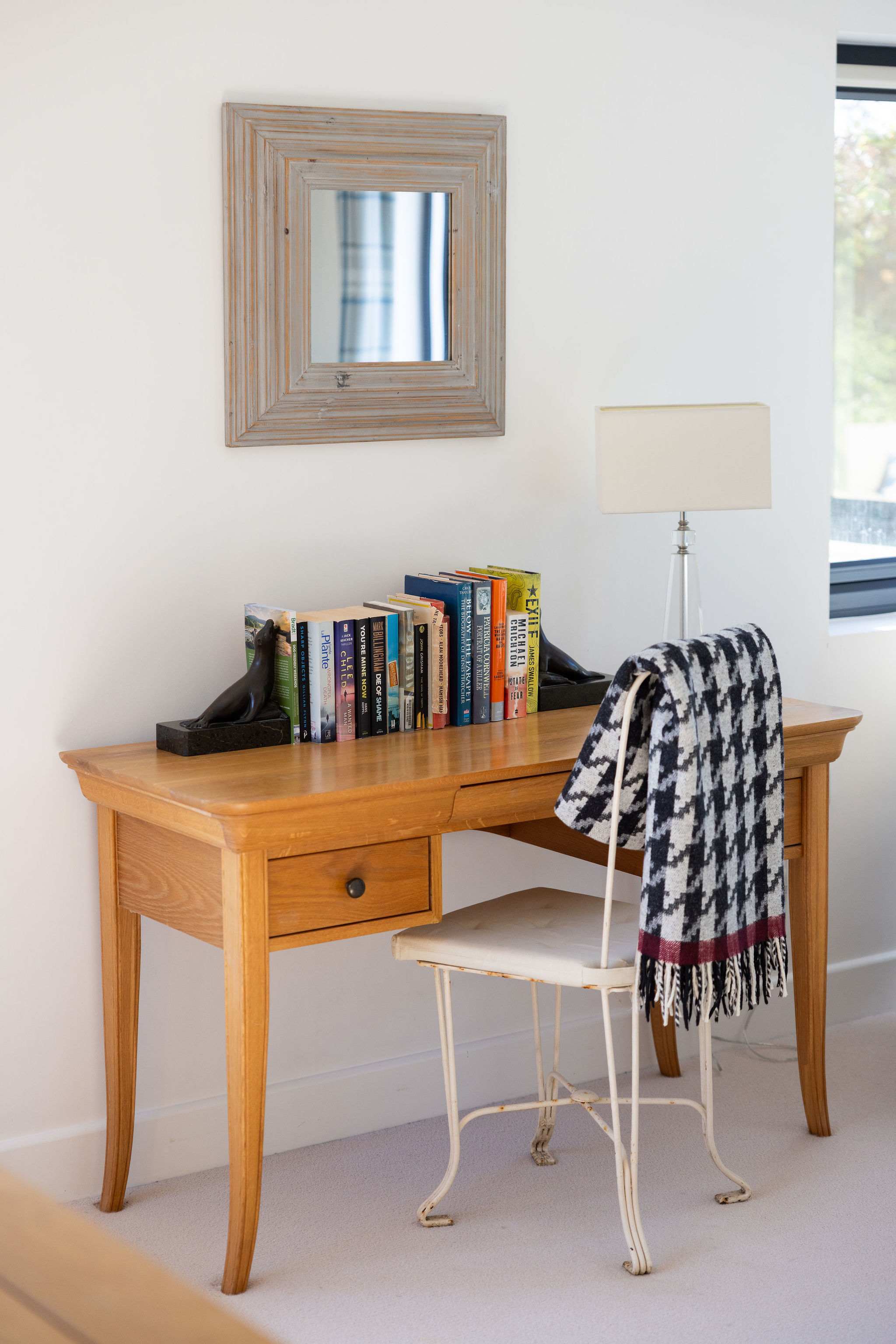 A charming and well-appointed desk area, perfect for reading or working.
