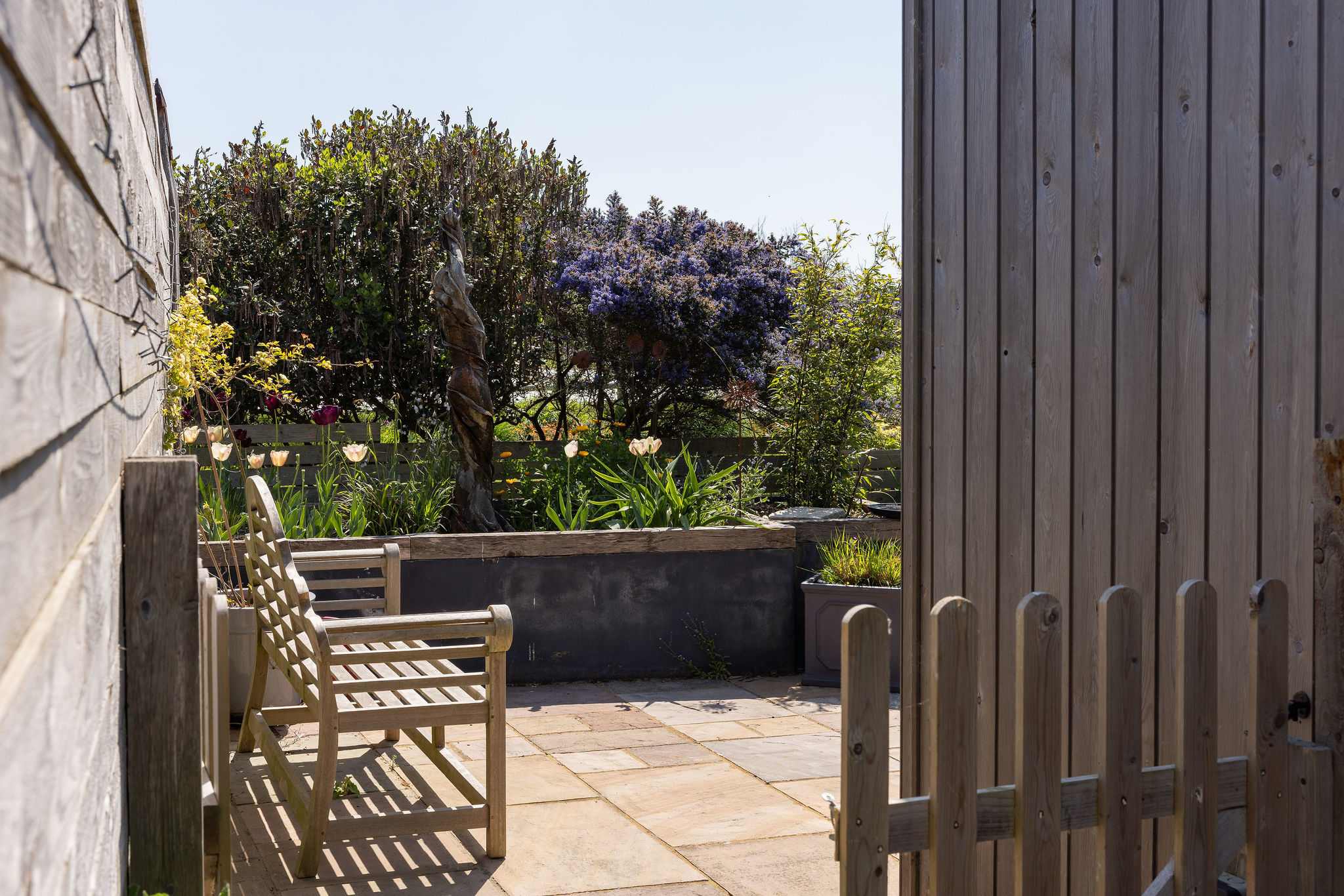 Private patio area with seating, perfect for enjoying the garden.