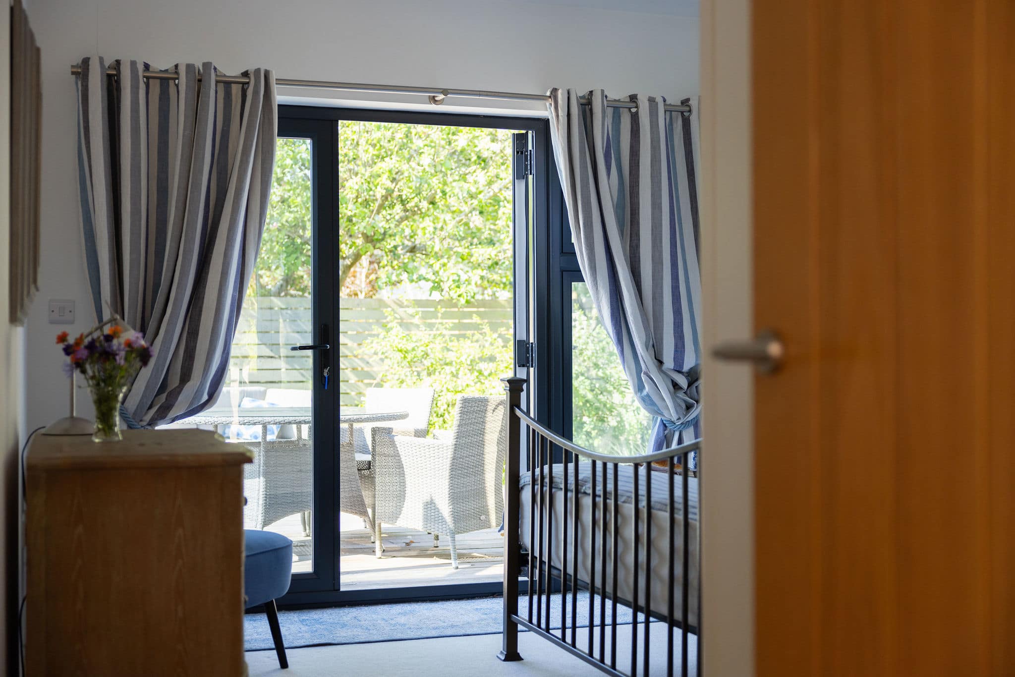 Wake up to views of the tranquil patio from this comfortable bedroom.