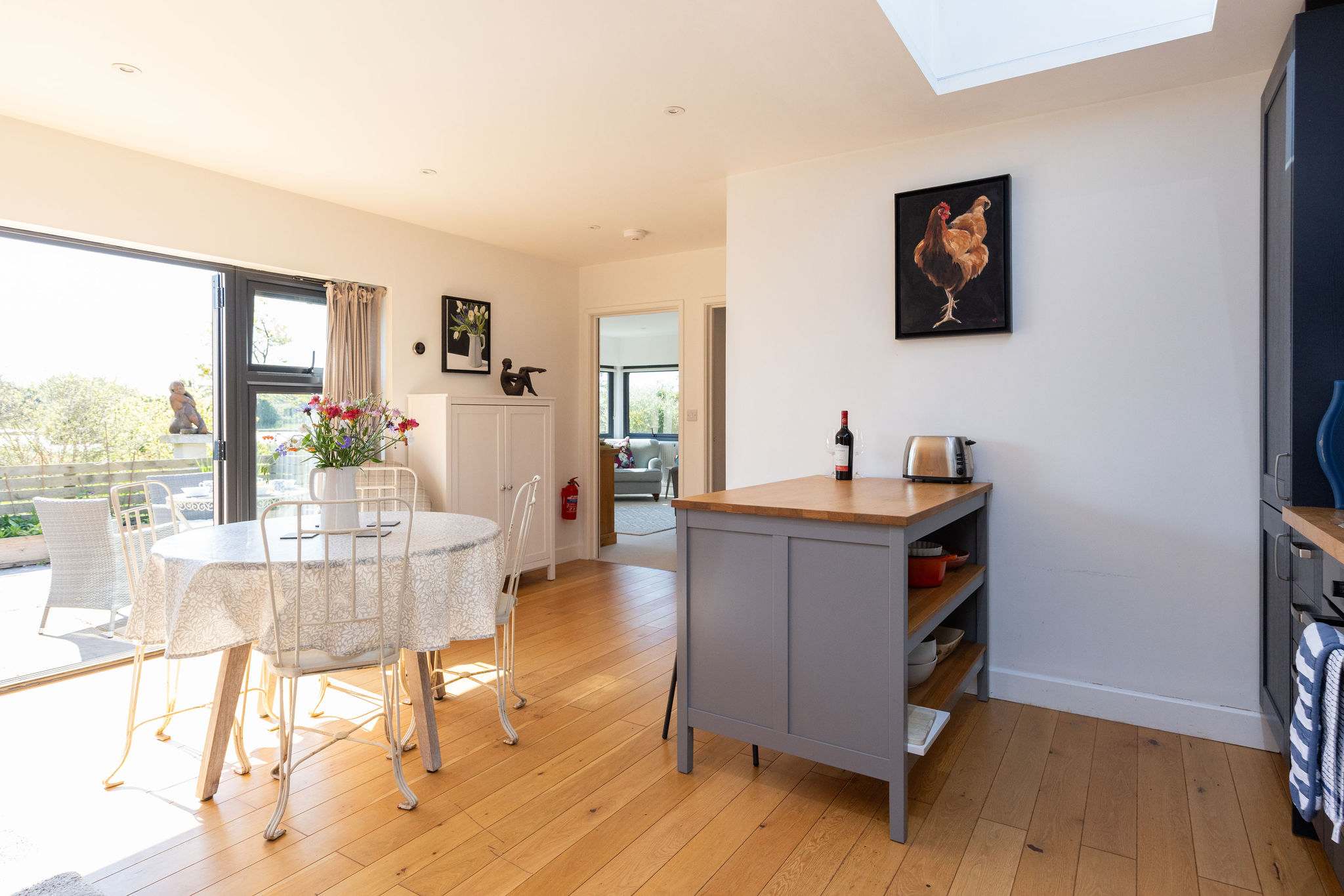 A bright and inviting kitchen and dining space with a stylish grey island.