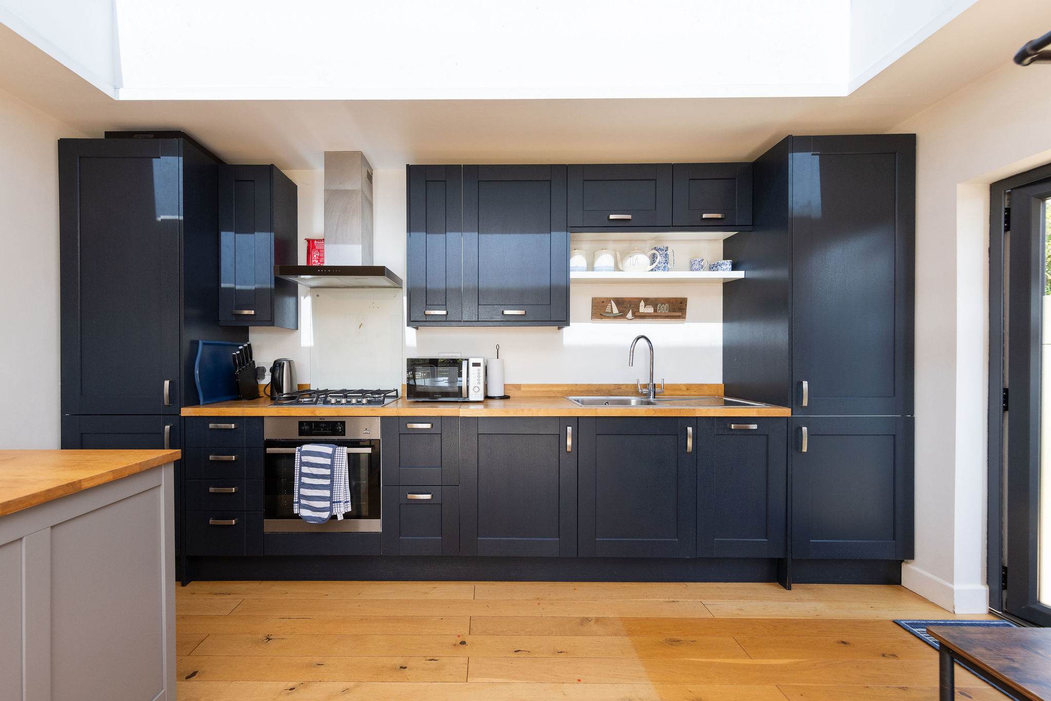 Stylish navy kitchen with warm wood accents, perfect for cooking with your family.