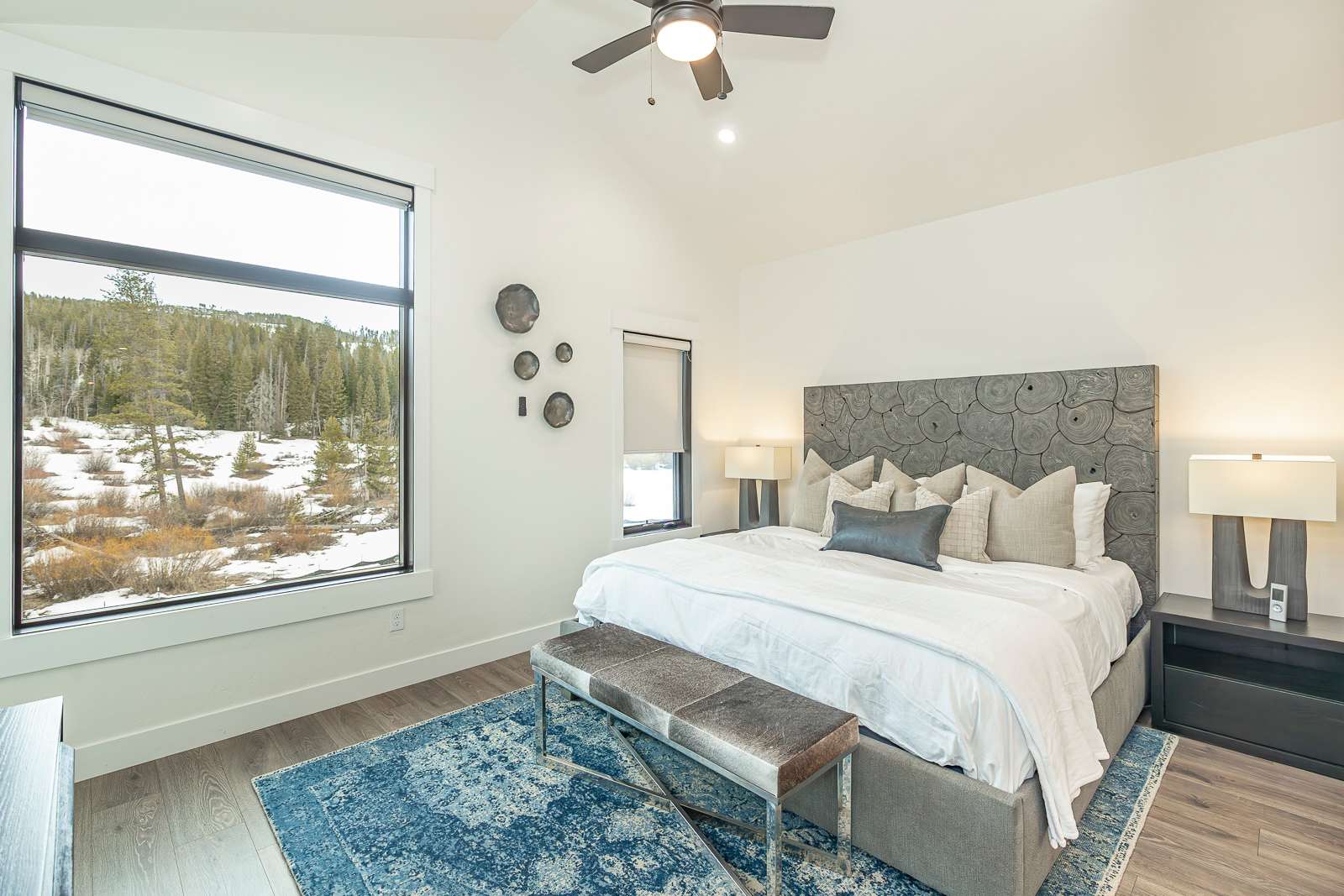 - Spacious and charming king suite with serene forest views and soft natural lighting
- Bold area rug and plush bench add a pop of texture and comfort
- Wake up to mountain vistas and quiet style every single morning