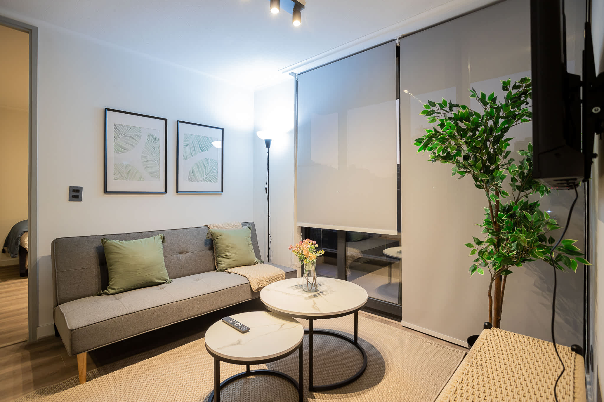 Relax in this stylish living room featuring chic decor, natural light, and a cozy atmosphere perfect for unwinding.