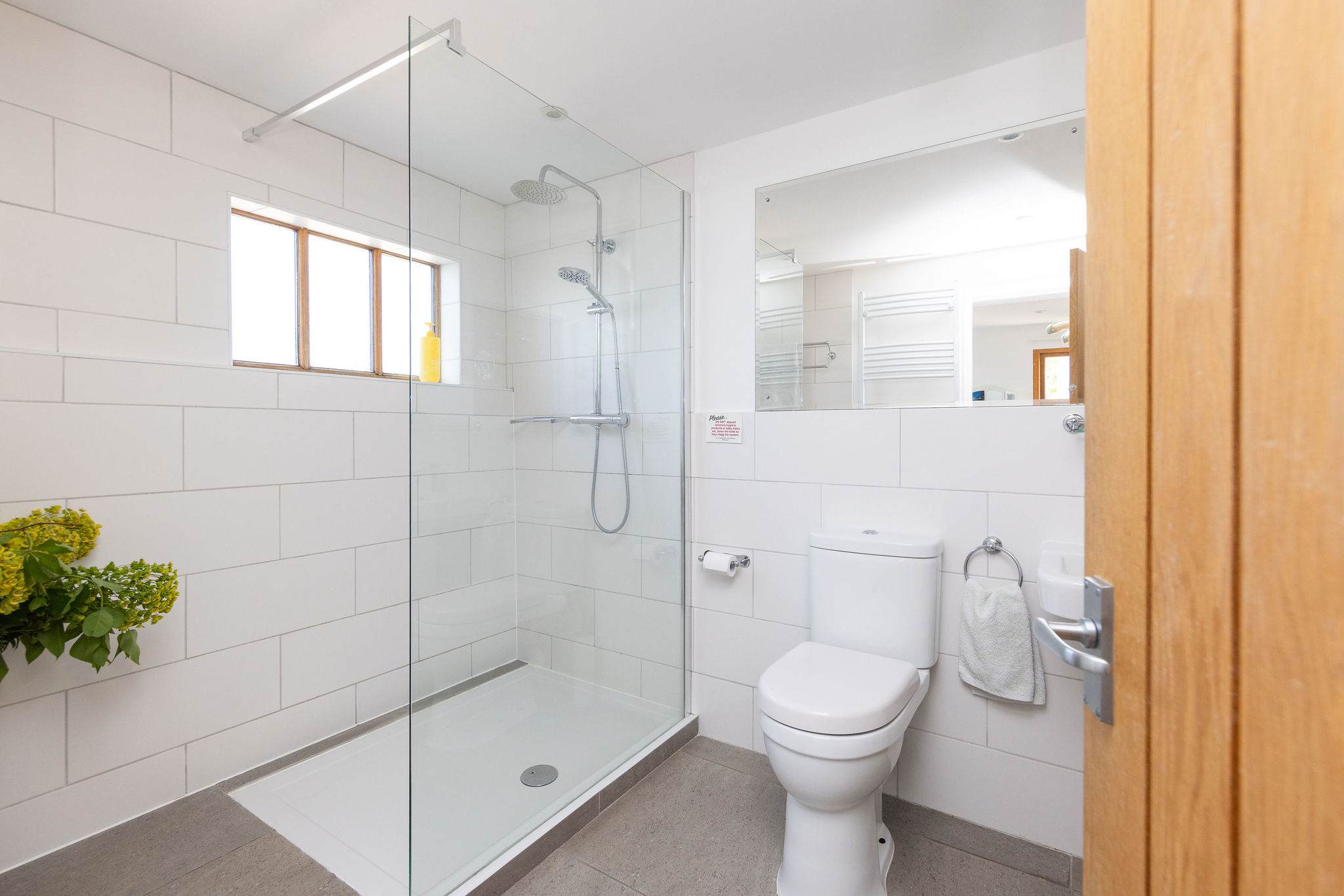 Modern bathroom with spacious walk in shower, sink and WC.