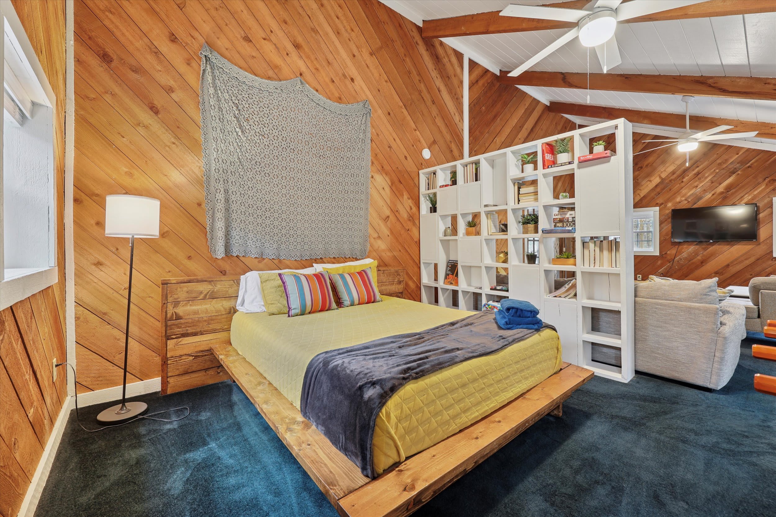 Rest easy in this main-level bedroom with a cozy platform bed and stylish macrame accents.