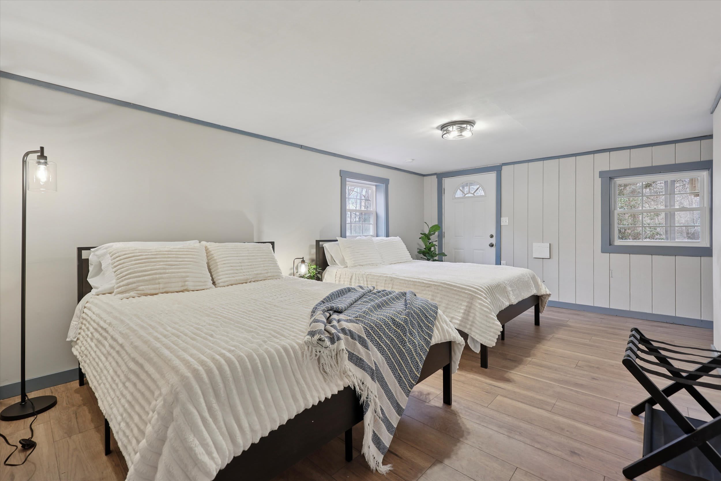 Crisp white walls and natural light create a restful space in this bedroom.