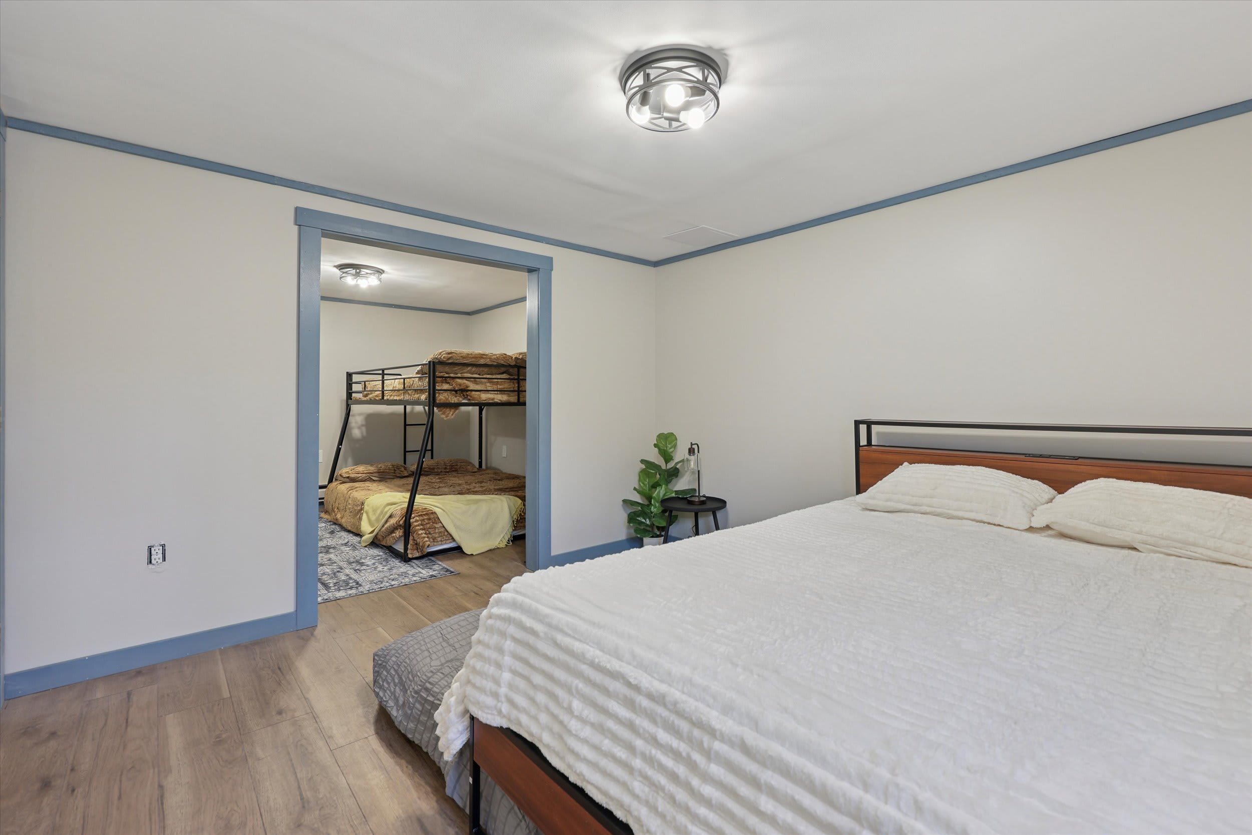 The lower level offers a bed with bunk beds just around the corner.
