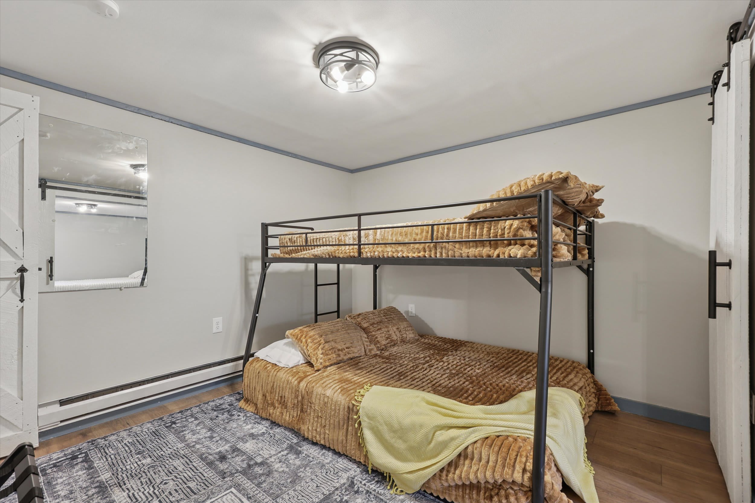 Snuggle into the soft faux fur bedding on the bunk bed for a camp-style sleep.