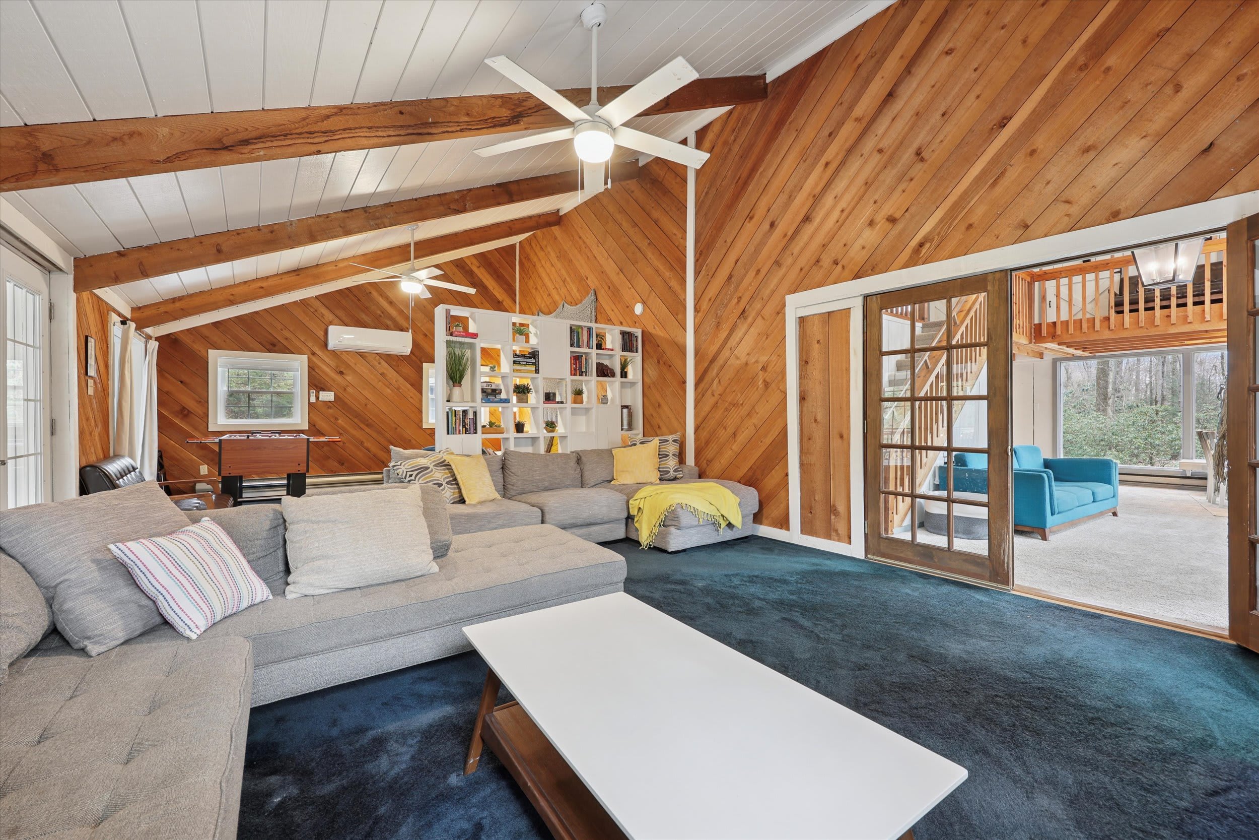 Gather in the open living space with views up to the loft and easy access to the enclosed porch.