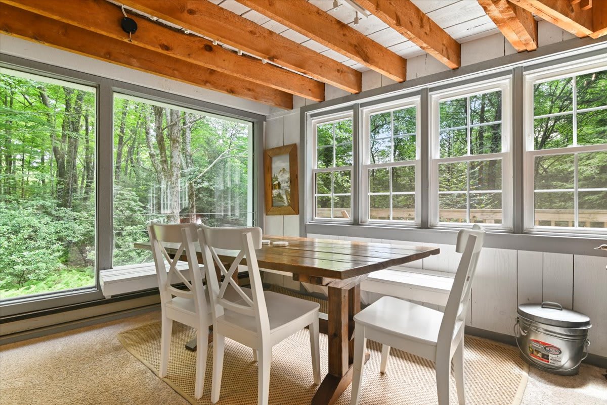 Linger over morning coffee at the farmhouse table surrounded by floor-to-ceiling windows.