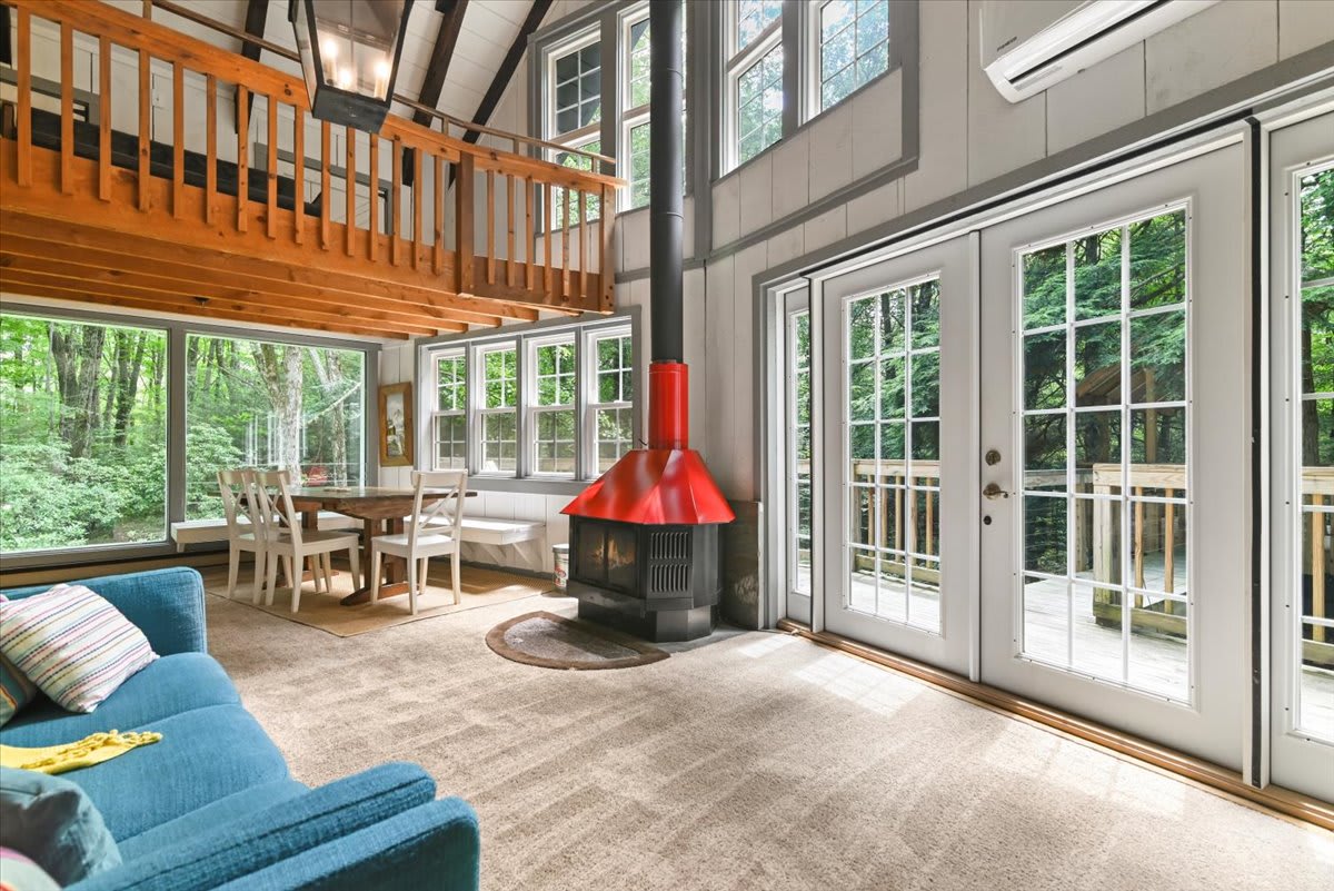The open kitchen and dining area offers stunning treetop views through picture windows.