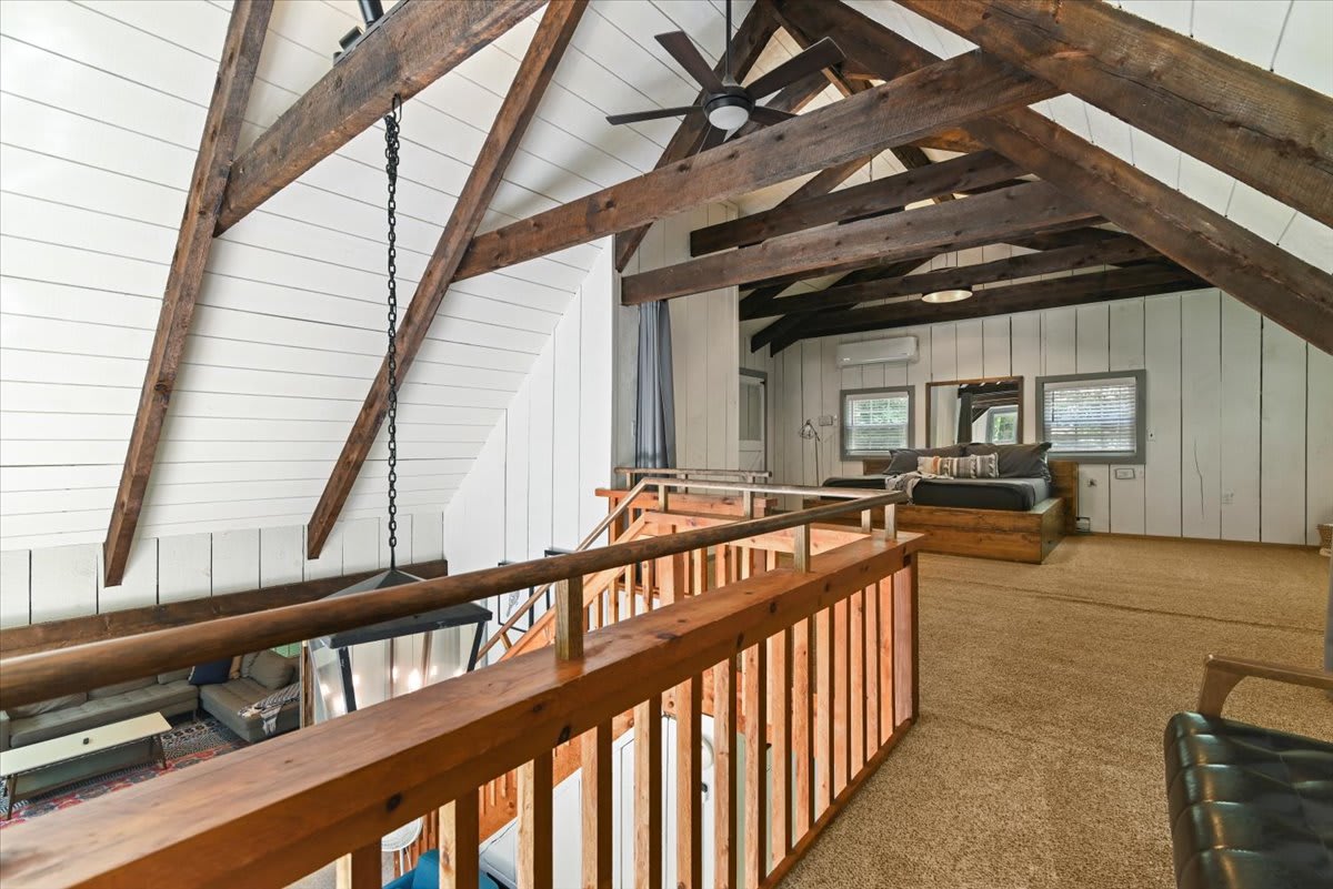 The loft bedroom retreat offers quiet privacy with views down to the living space below.