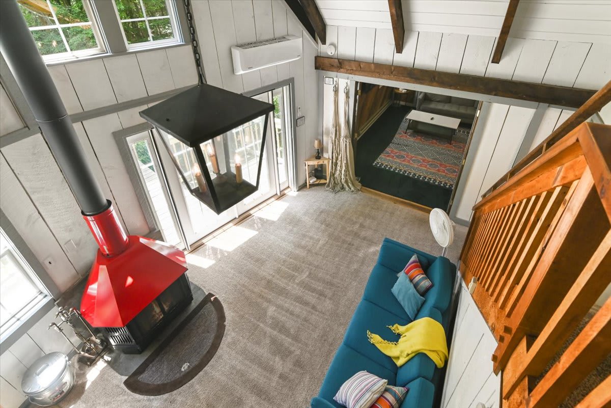 Gaze down from the loft at the dramatic open living space and statement pendant light.