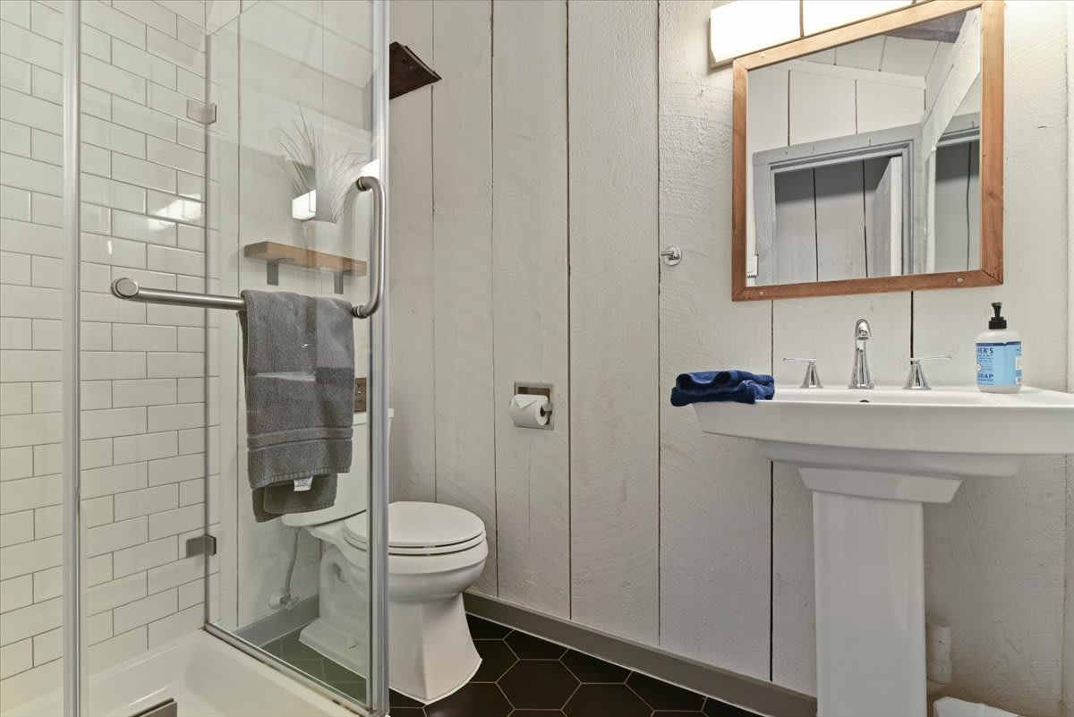 The loft bathroom includes a walk-in glass shower with a rain showerhead.