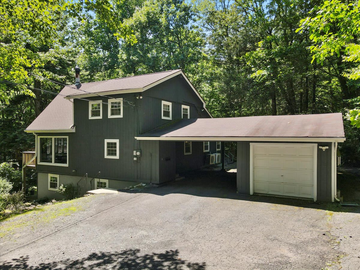 Arrive to the welcoming front entrance with a two-car garage and ample parking.