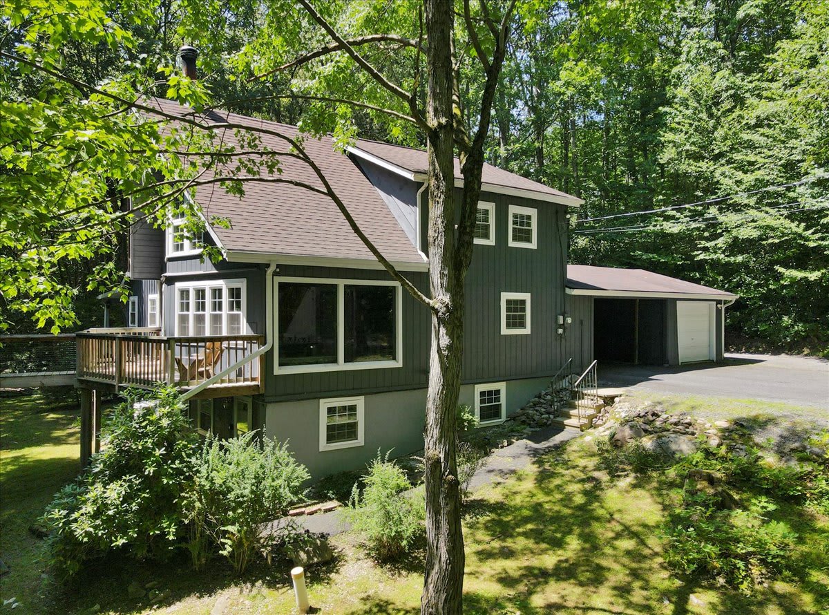 The chalet and tree house are connected by a sprawling lawn perfect for games or relaxation.