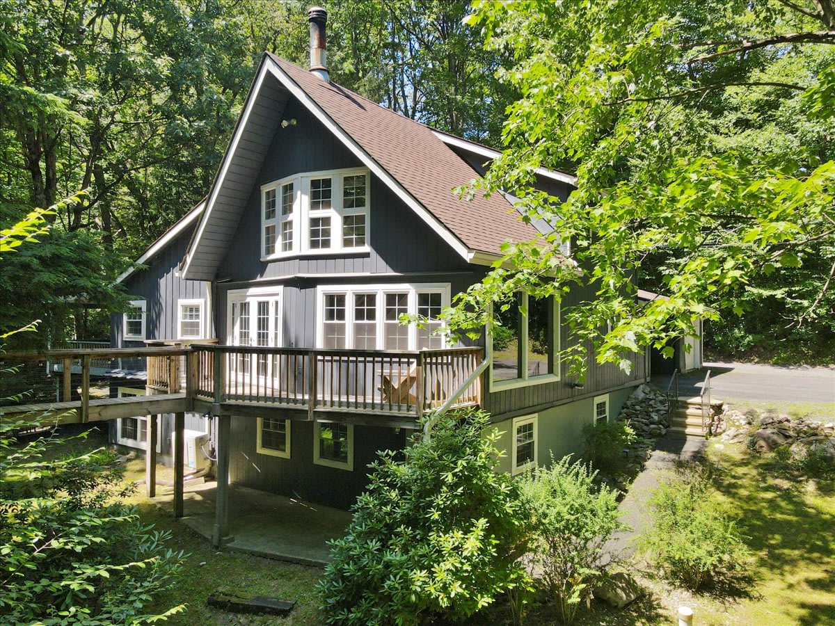 The dramatic A-frame design features a spacious deck with chairs for soaking in the view.