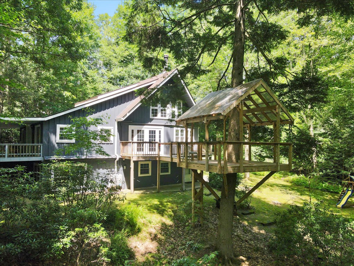 The private retreat includes the main house, tree house, and play area for kids.