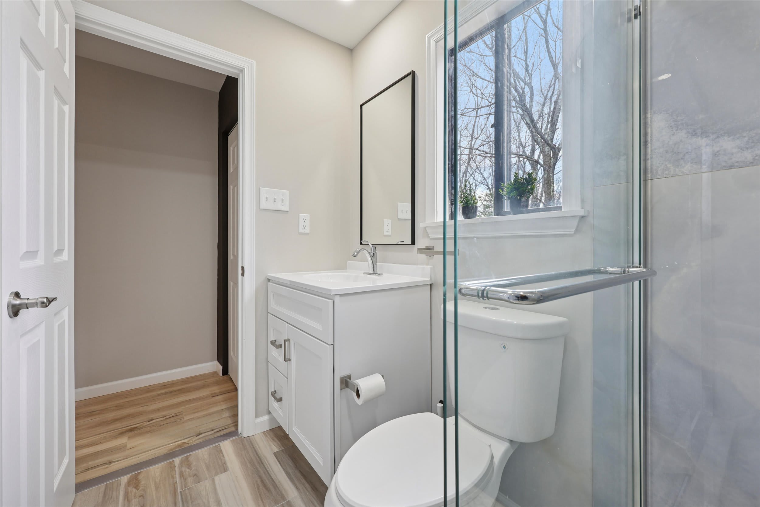 Bright bathroom with natural light and clean white finishes
