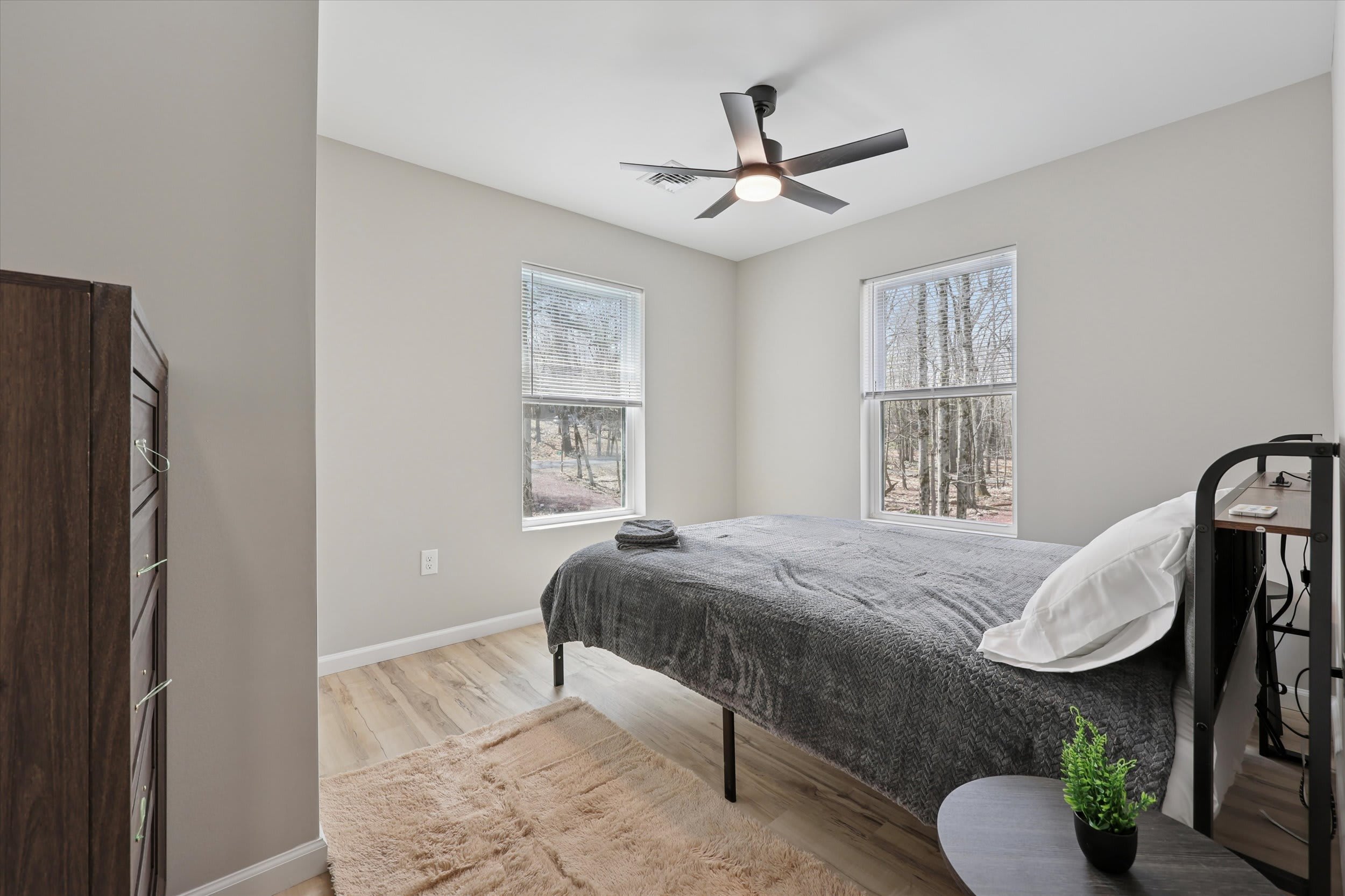 Restful king bed with ceiling fan for year-round comfort