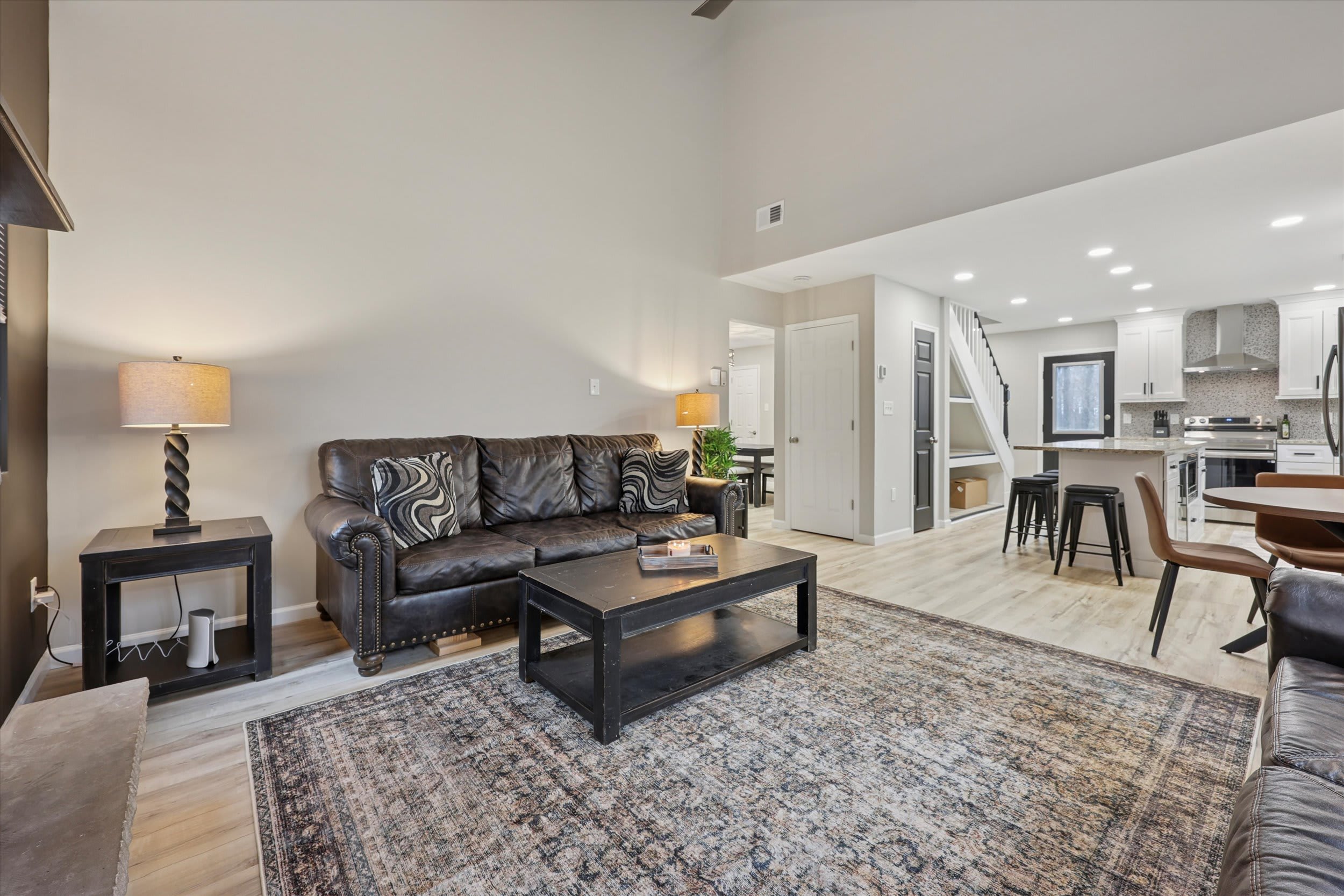 Large windows bring the wooded view inside from the living room