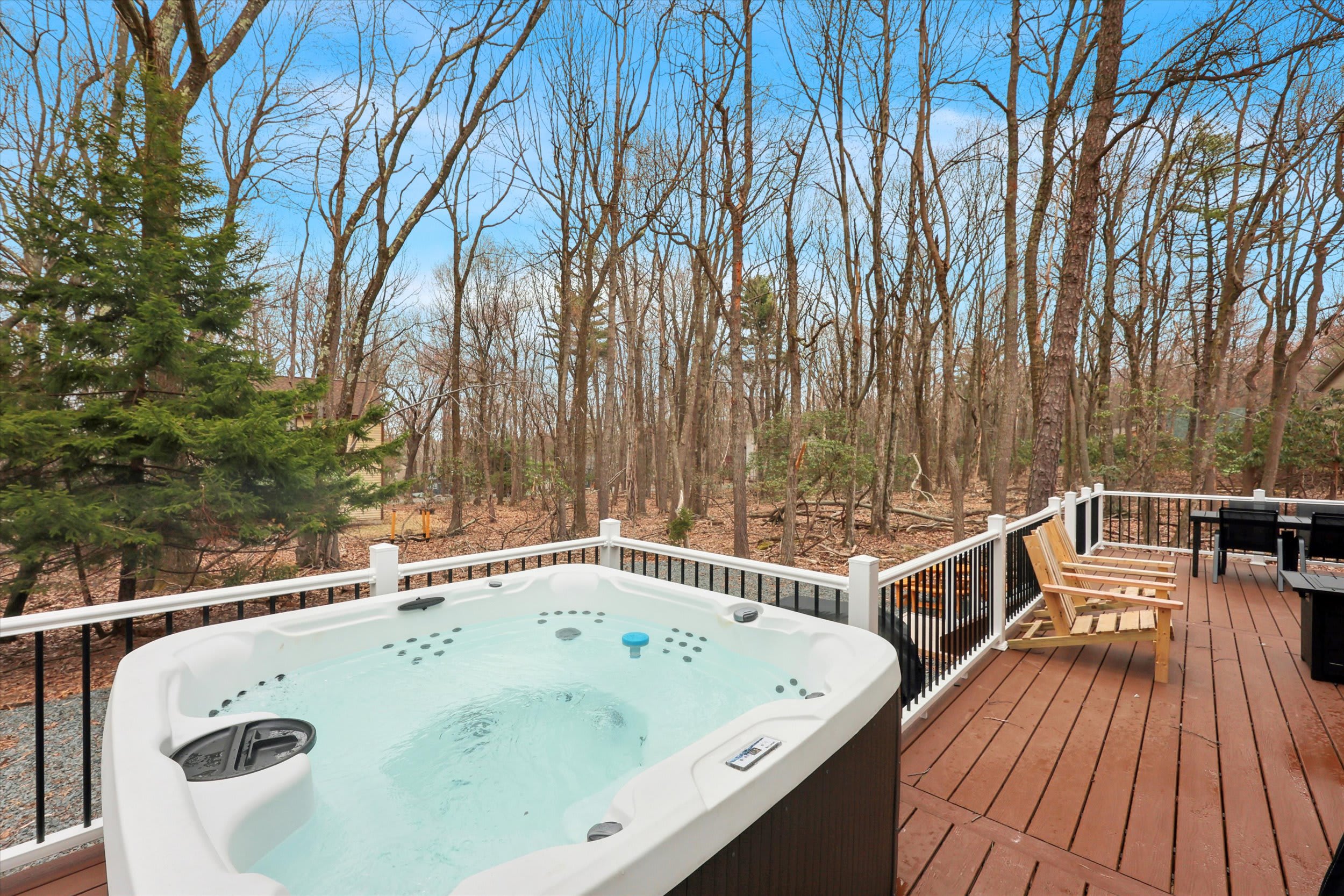 Soak and unwind in the hot tub surrounded by trees and fresh mountain air