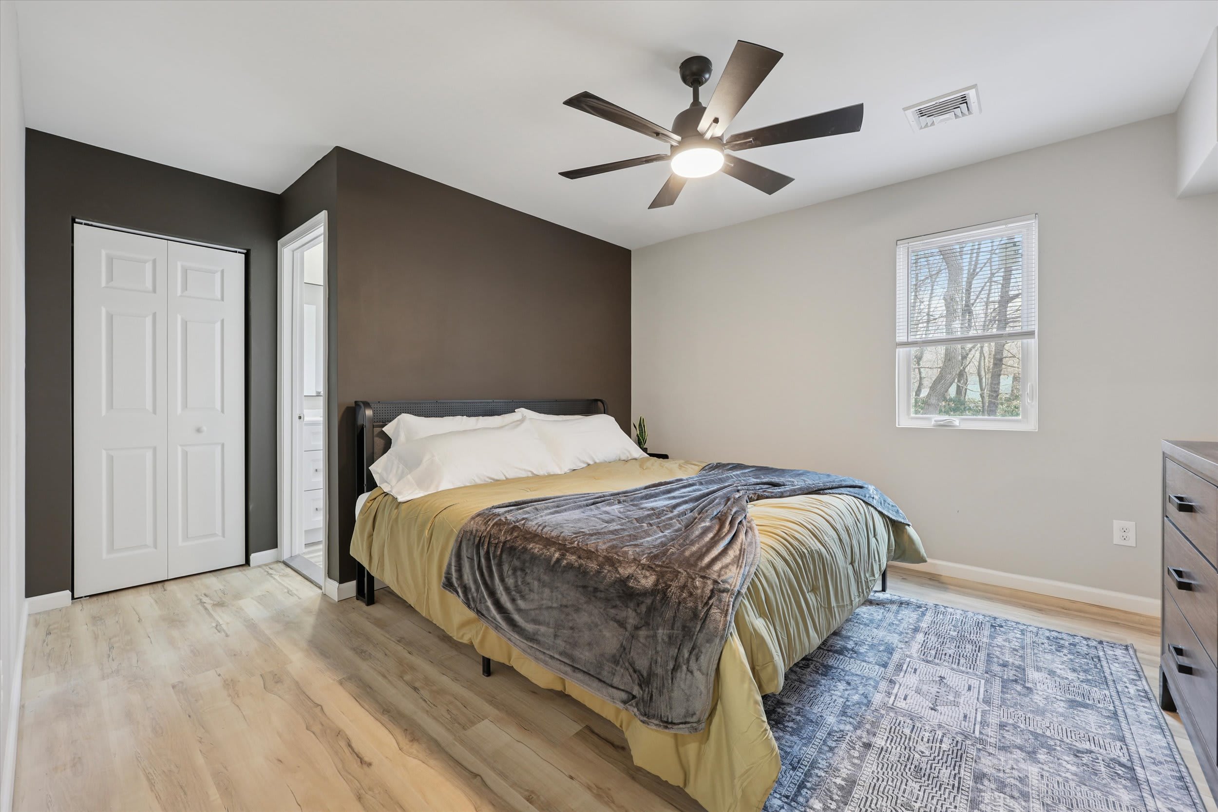 Restful king bed awaits in this comfortable bedroom with ceiling fan