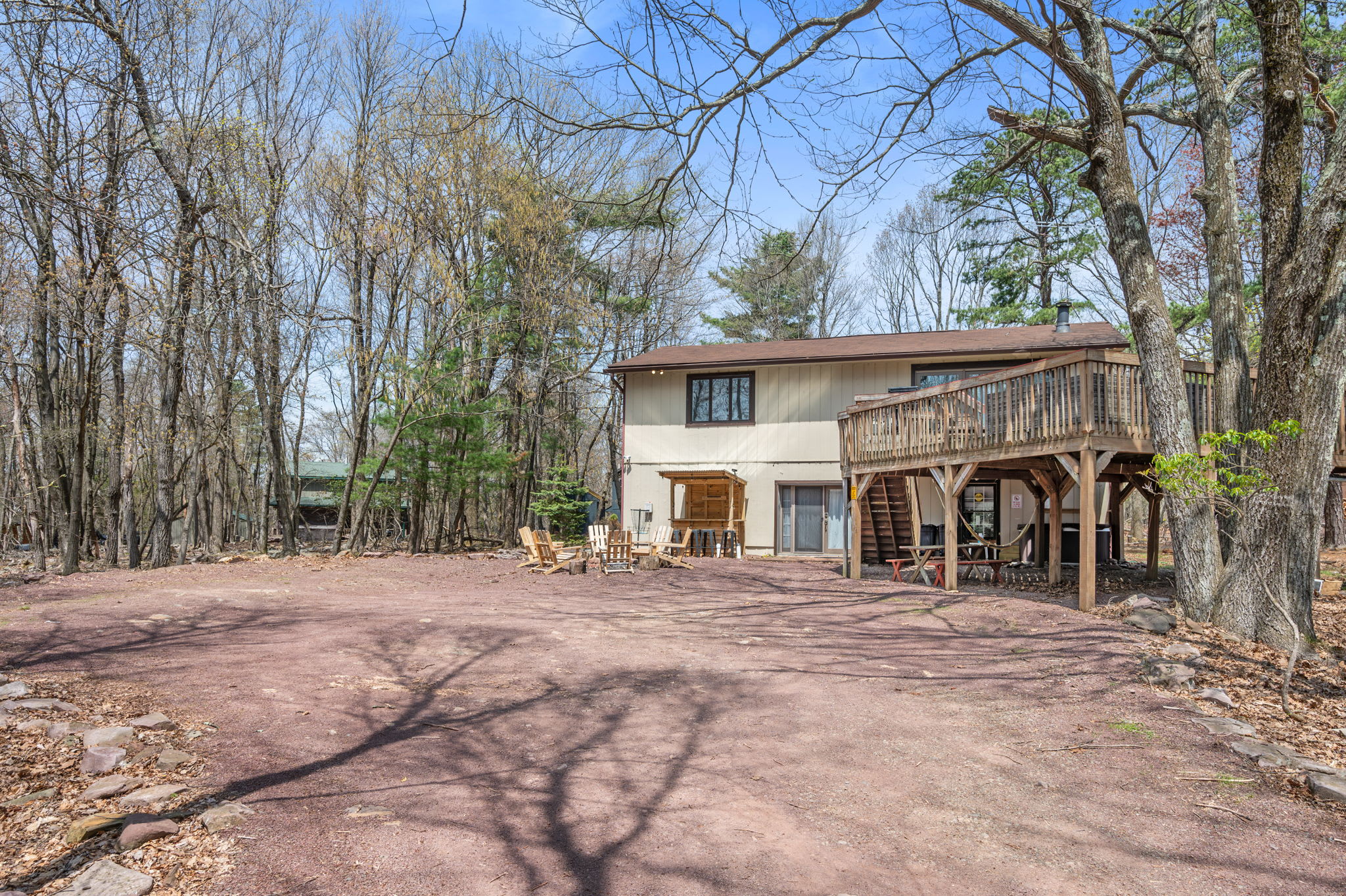 Arrive at your private getaway with ample parking and a welcoming wooded setting