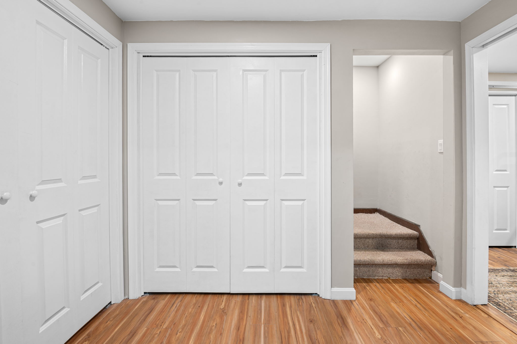 Welcoming entryway with ample closet storage and access to all levels of the home