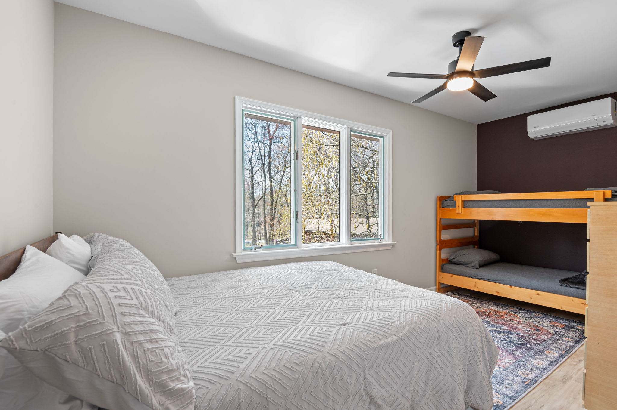 Inviting bedroom with ceiling fan and cozy area rug for relaxing mountain nights