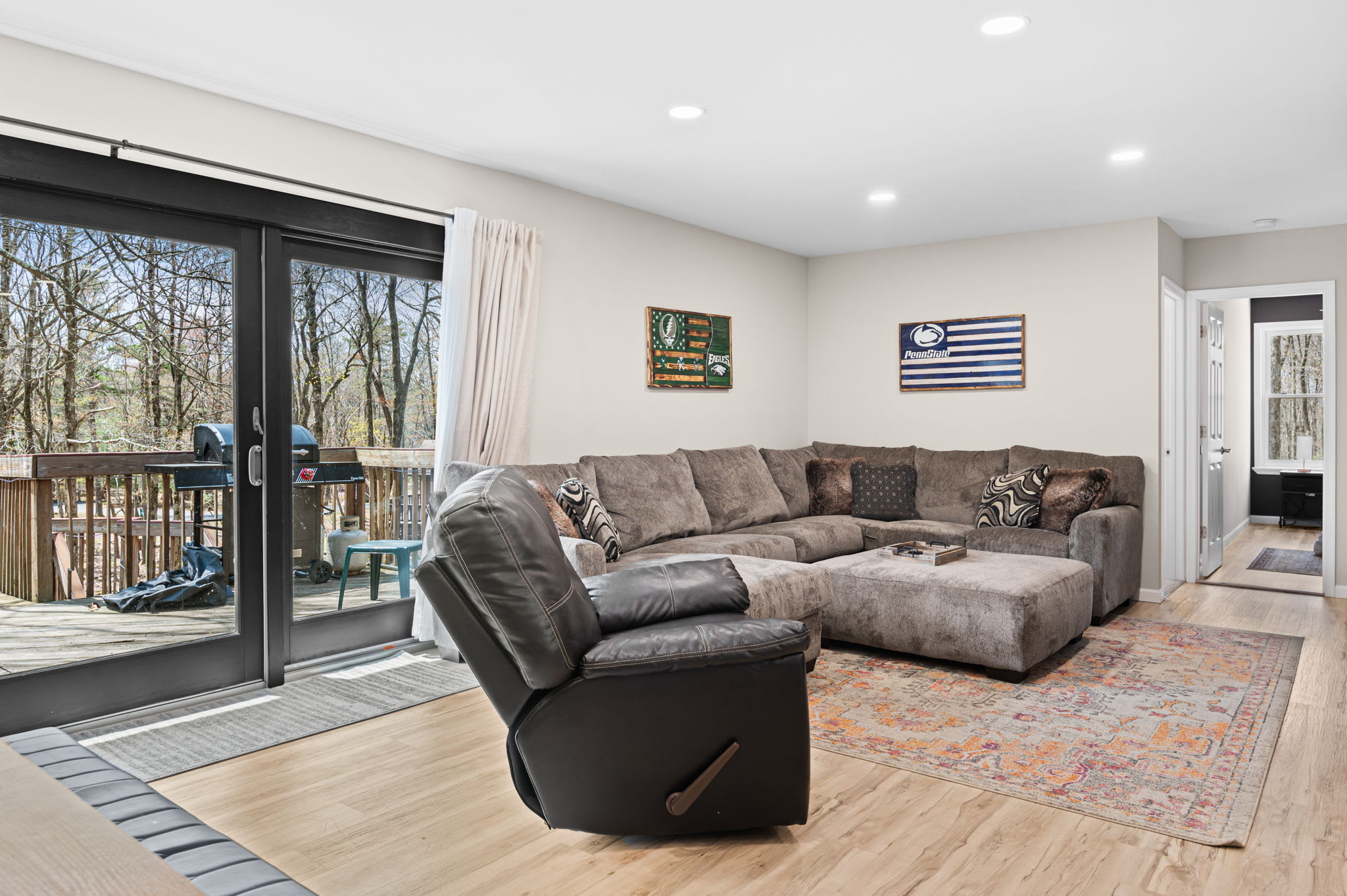 Relax on the plush sectional with deck views and outdoor grilling just steps away