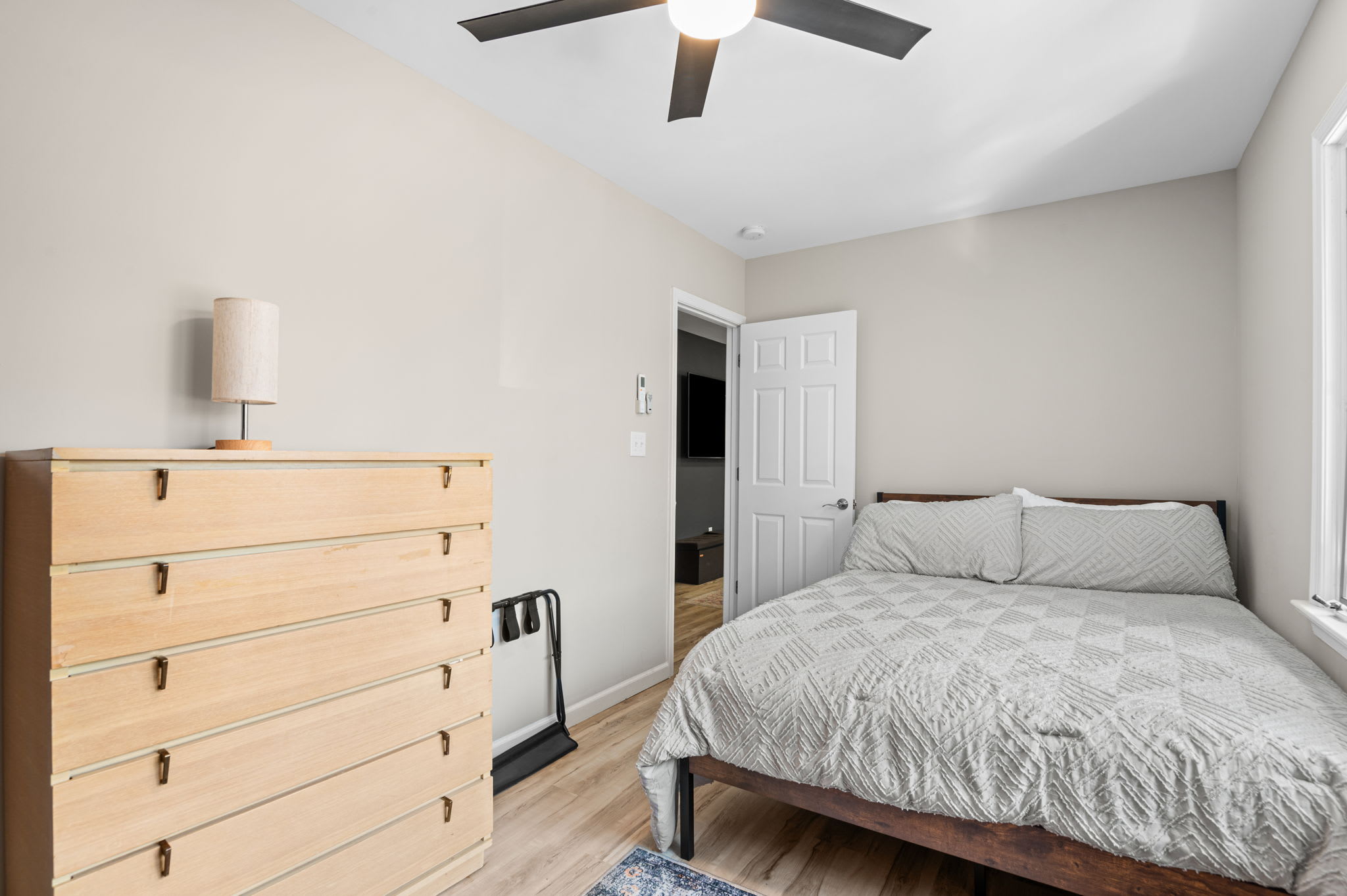 Comfortable bedroom with dresser storage and soft lighting for a peaceful retreat