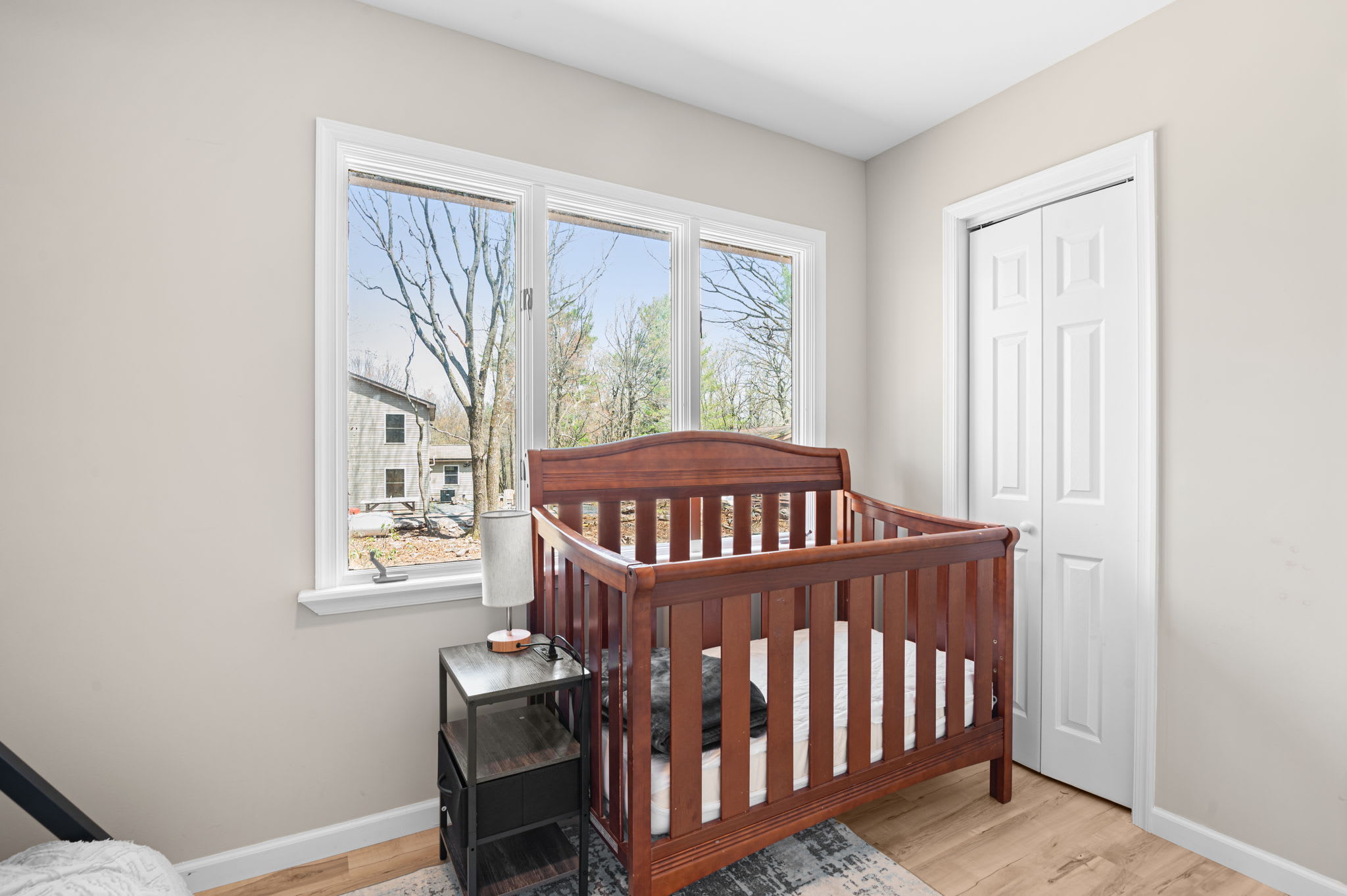 Family-friendly room with crib and wooded views for little ones to rest