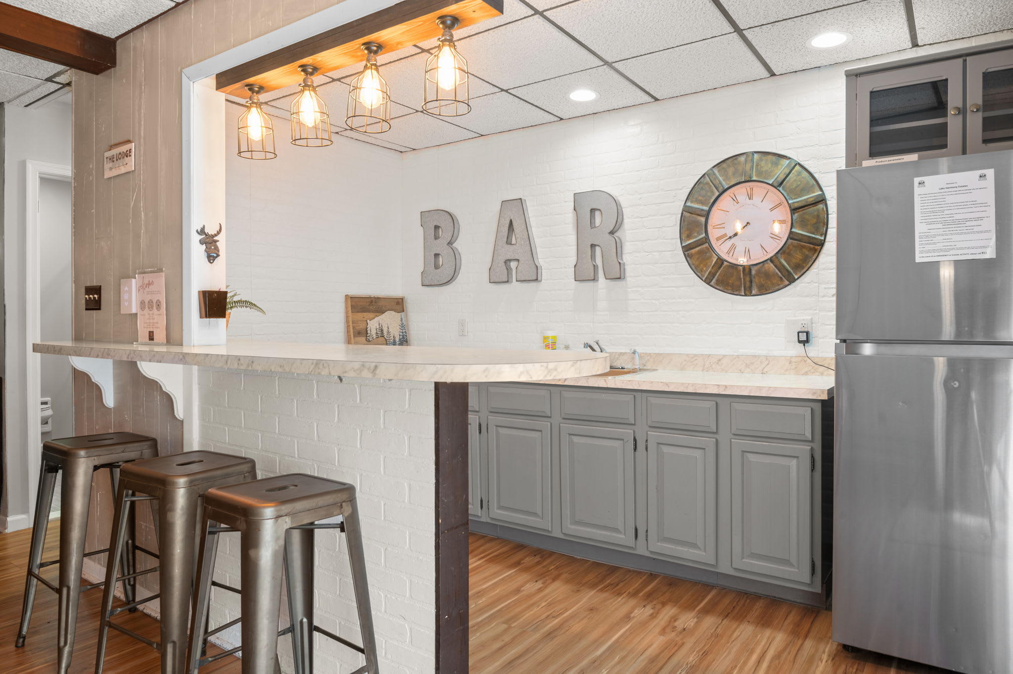 Mix drinks at the bar under stylish pendant lights and a vintage clock