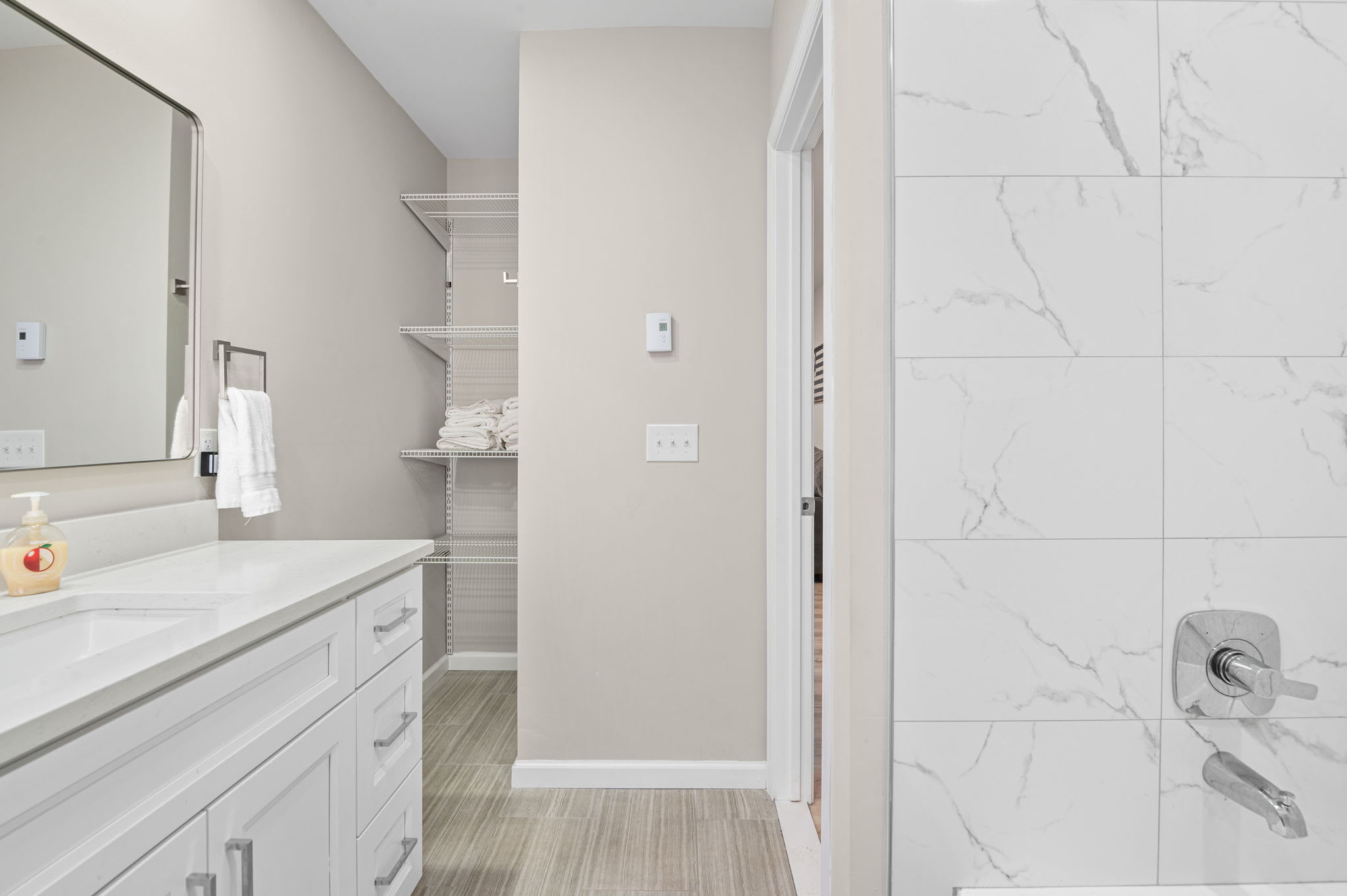 Spacious bathroom with walk-in shower and updated fixtures for your comfort