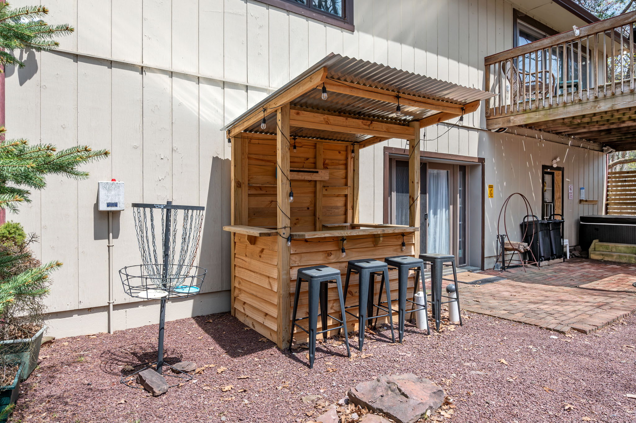 Outdoor tiki bar with string lights perfect for evening drinks under the stars