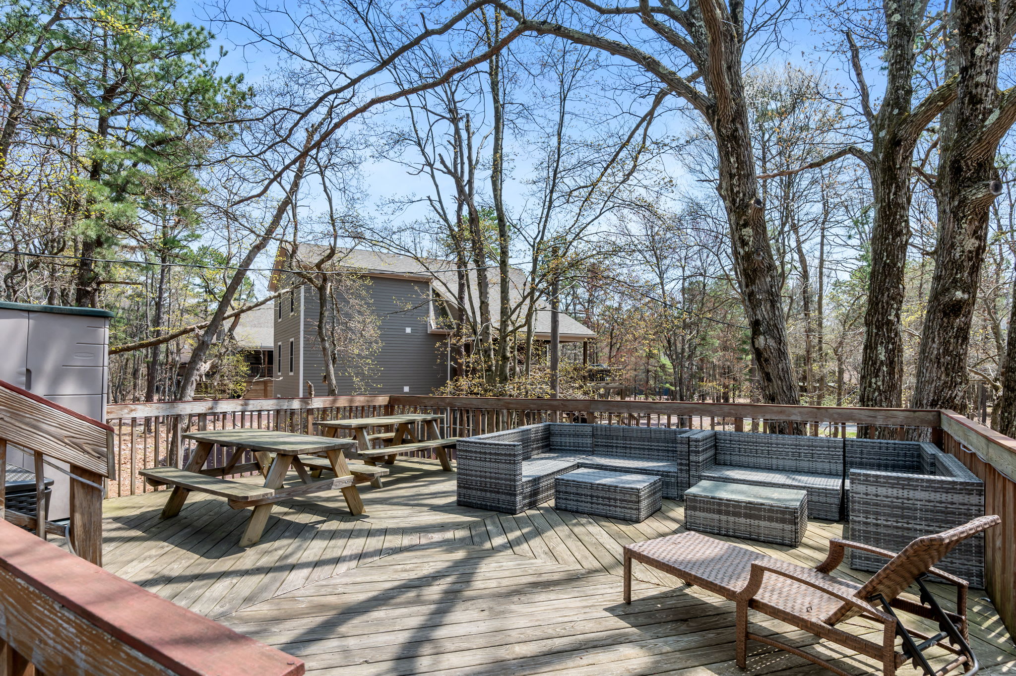 Expansive rear deck with outdoor dining and grill for Poconos summer gatherings
