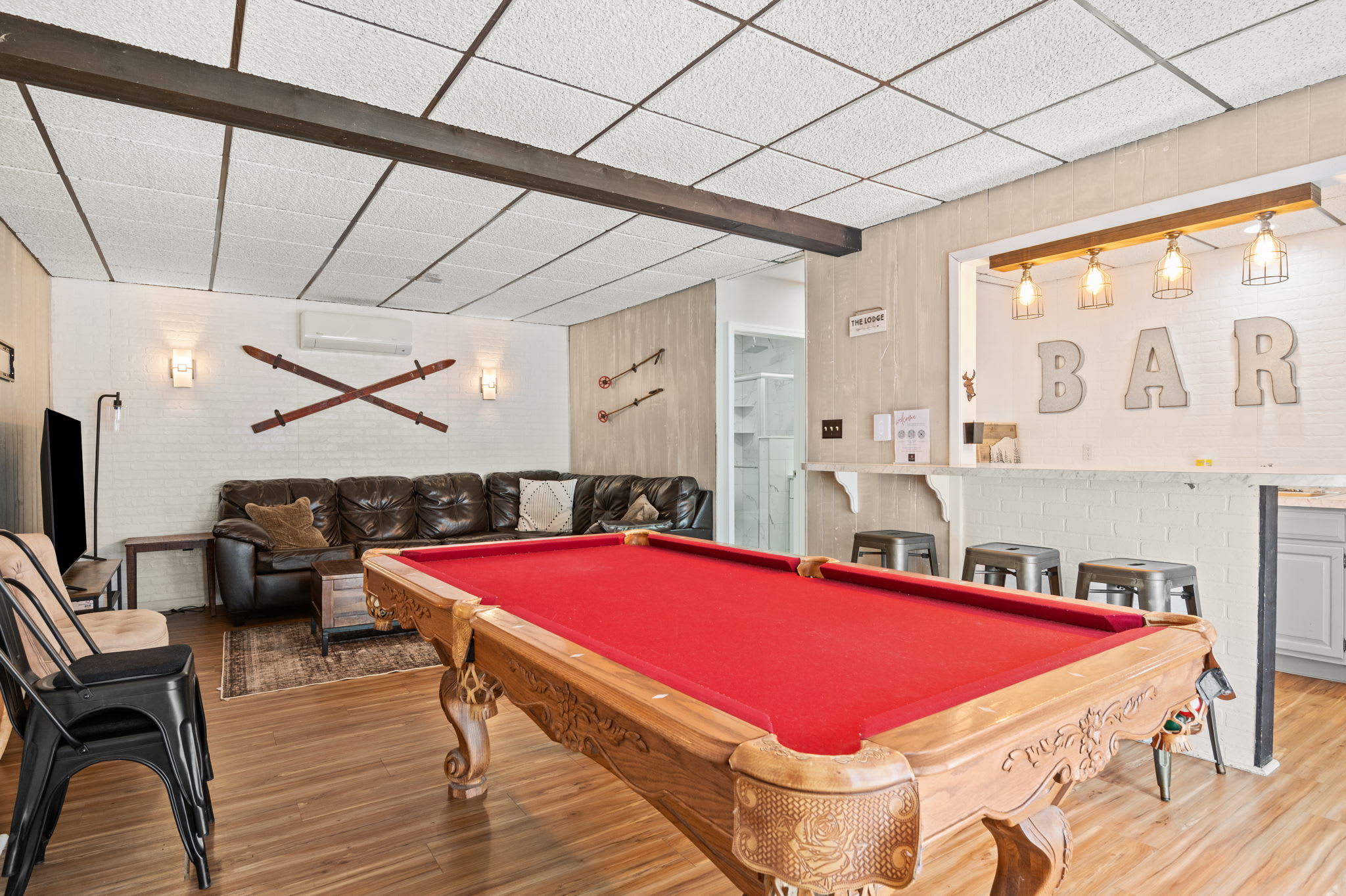 Leather seating and a pool table make this game room perfect for friendly competition