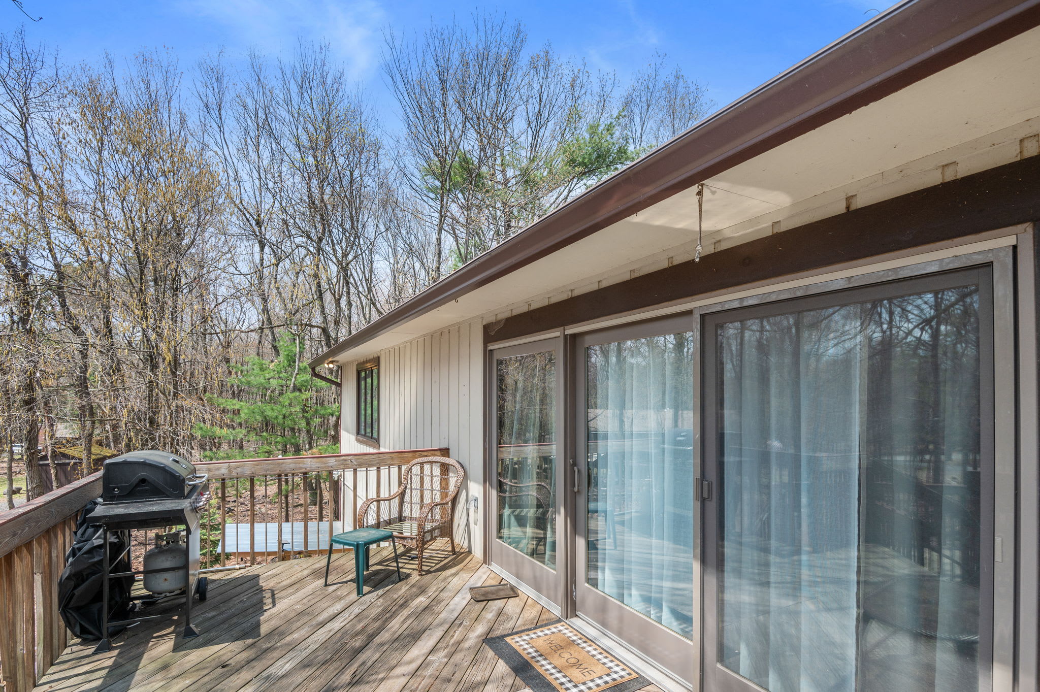 Spacious deck with outdoor seating and grill ready for summer barbecues in the Poconos