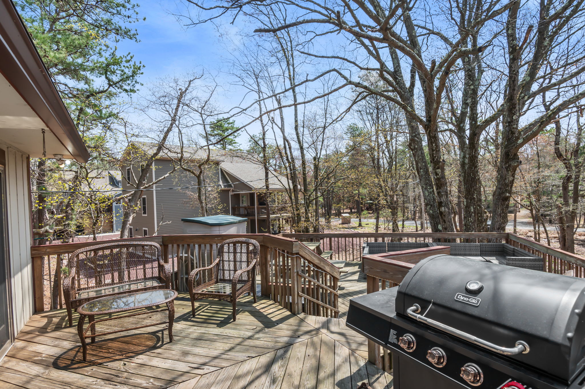 Enjoy outdoor grilling on the wraparound deck with wooded privacy in the Poconos
