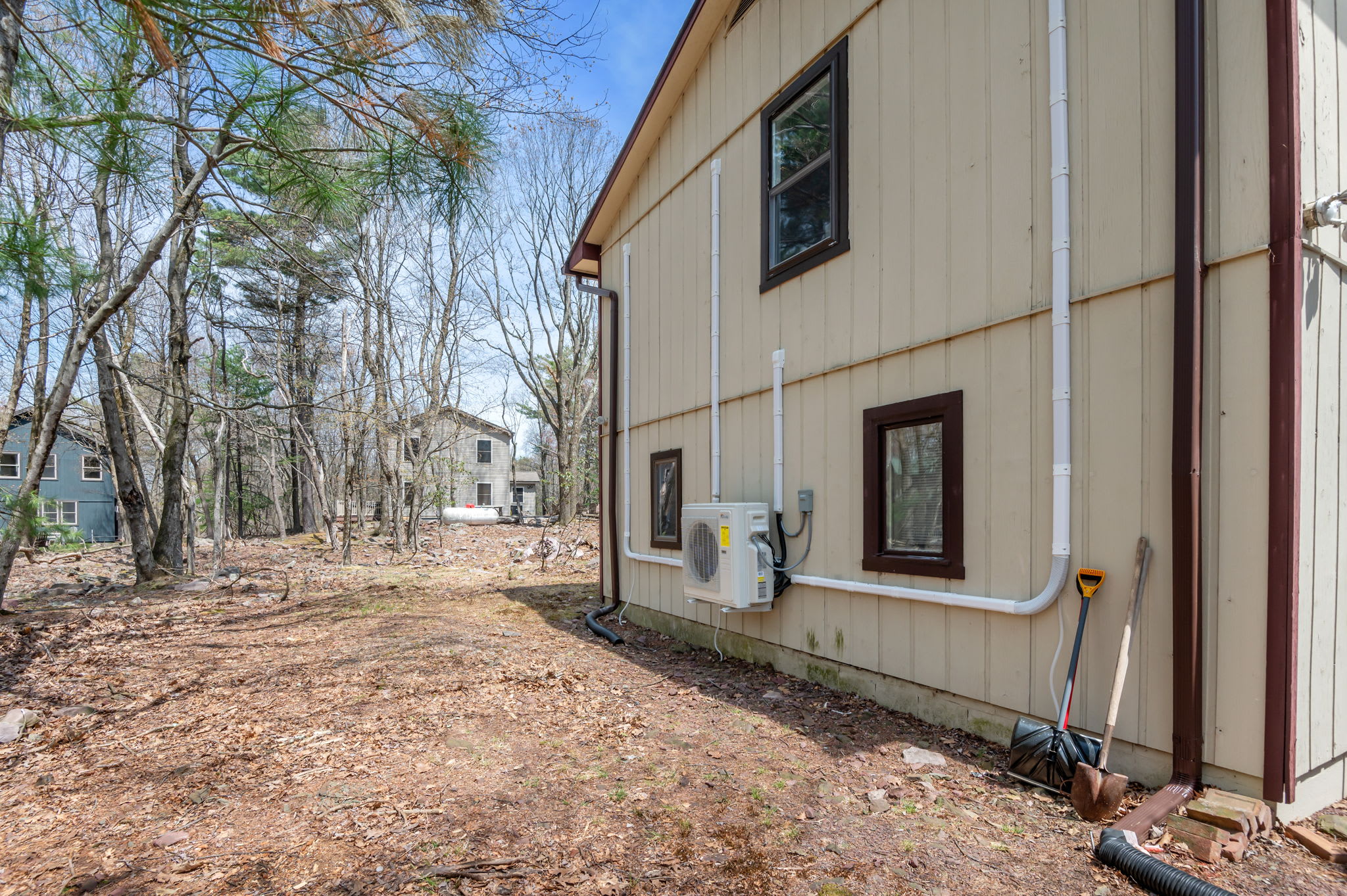 Side view of the lodge surrounded by mature trees and natural landscaping