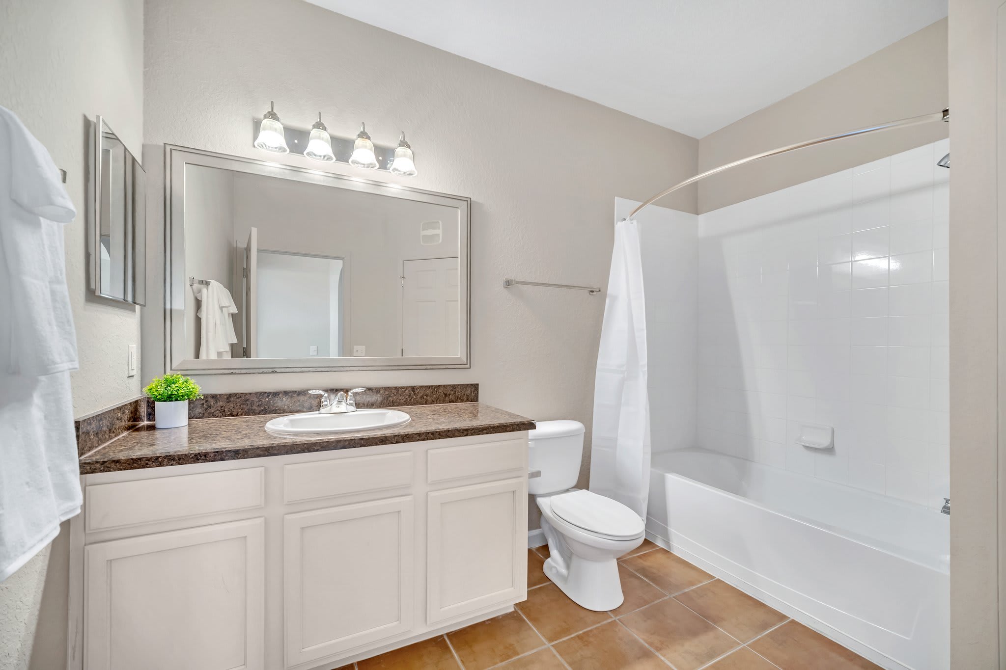 Full bathroom with combined shower and bathtub