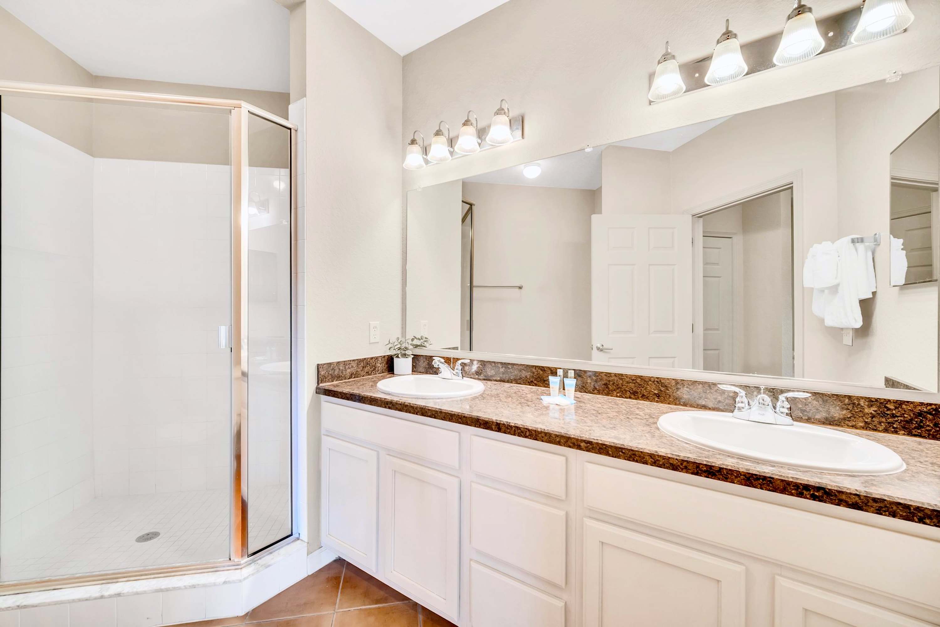 King en-suite bathroom with double vanity and standing shower