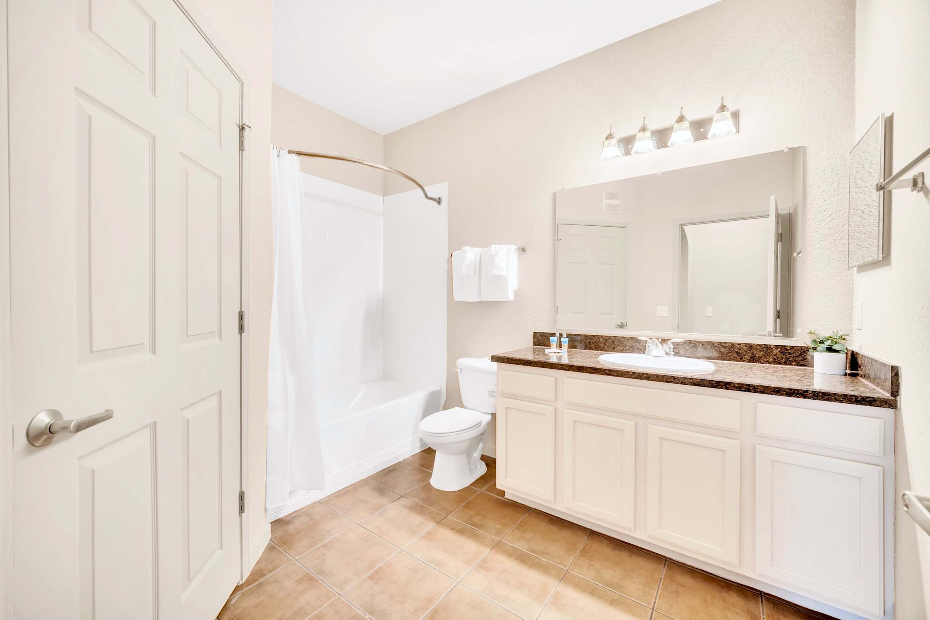 Full bathroom with combined bathtub and shower